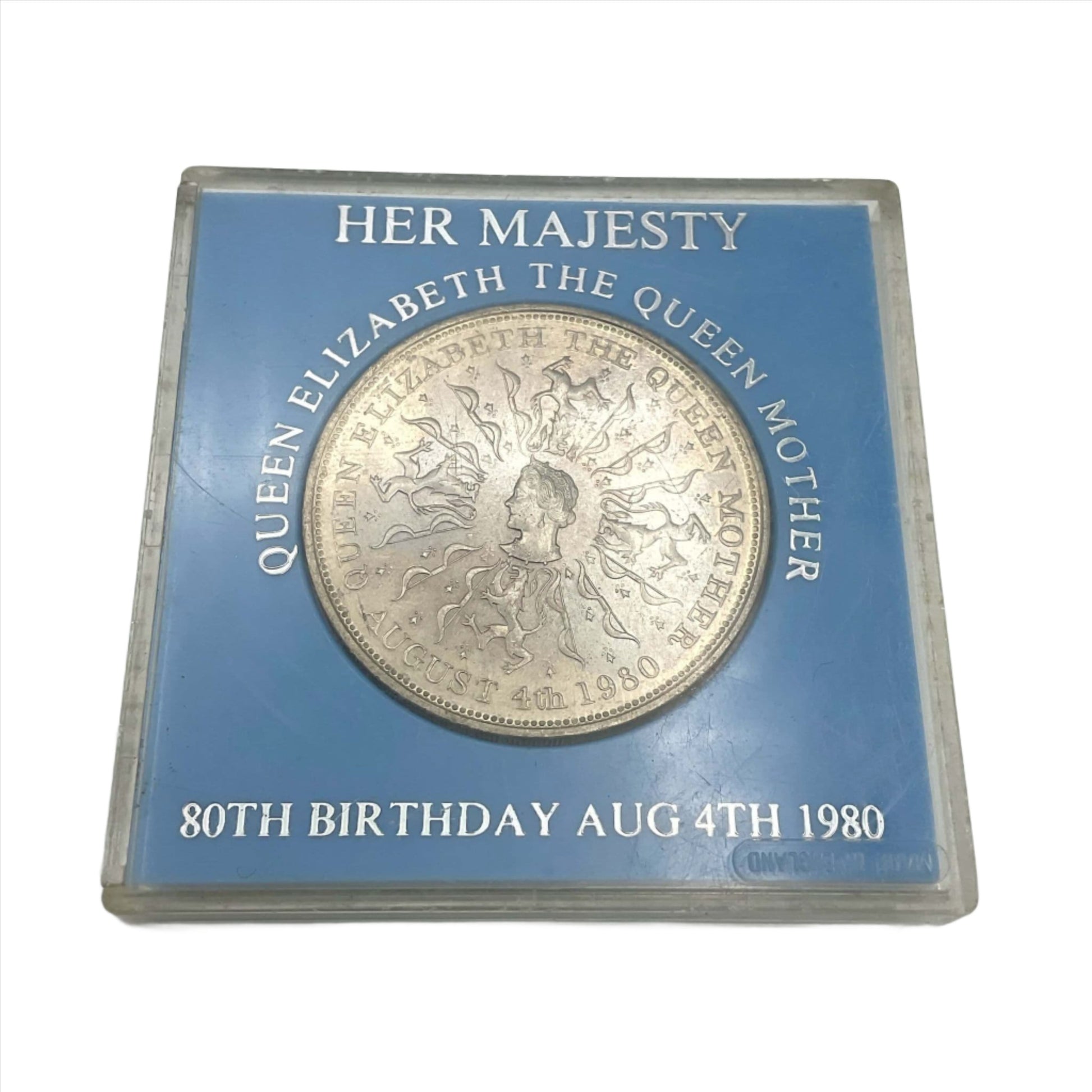 Silver coin featuring the Queen Mother's head in a light blue case
