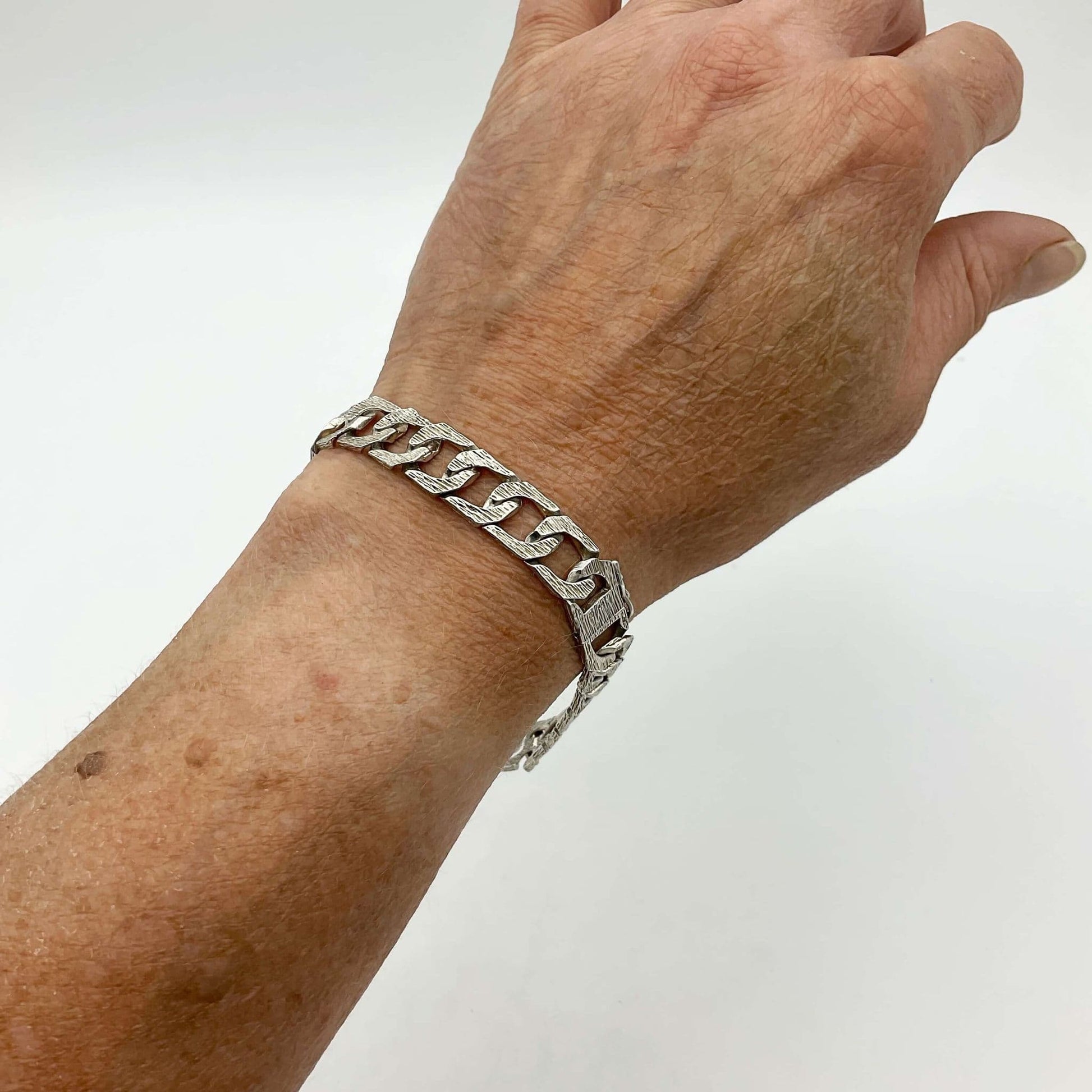 Silver chain bracelet on a wrist