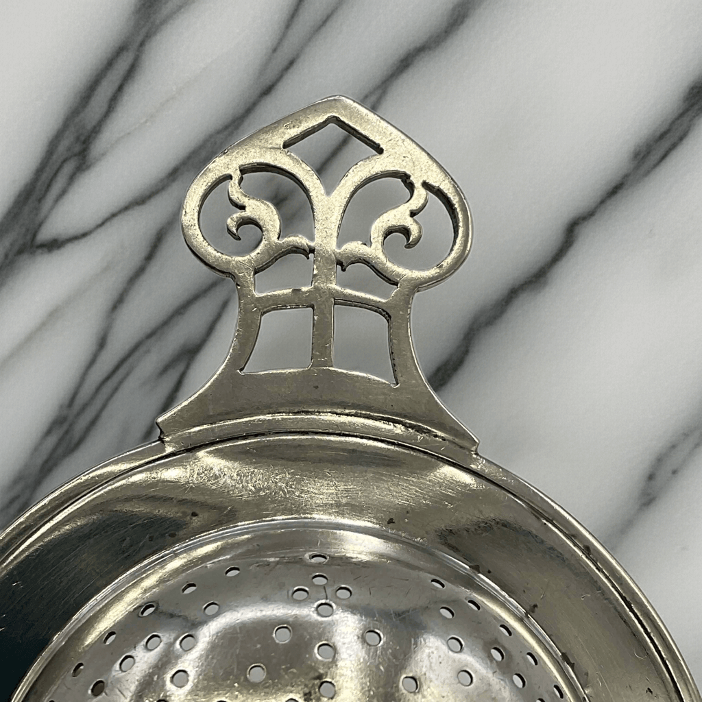 Antique 1925 sterling silver tea strainer with ornate design, crafted by Beeches Vintage, perfect for traditional tea brewing.