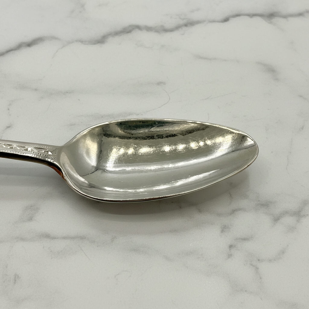 Silver spoon on a marble surface