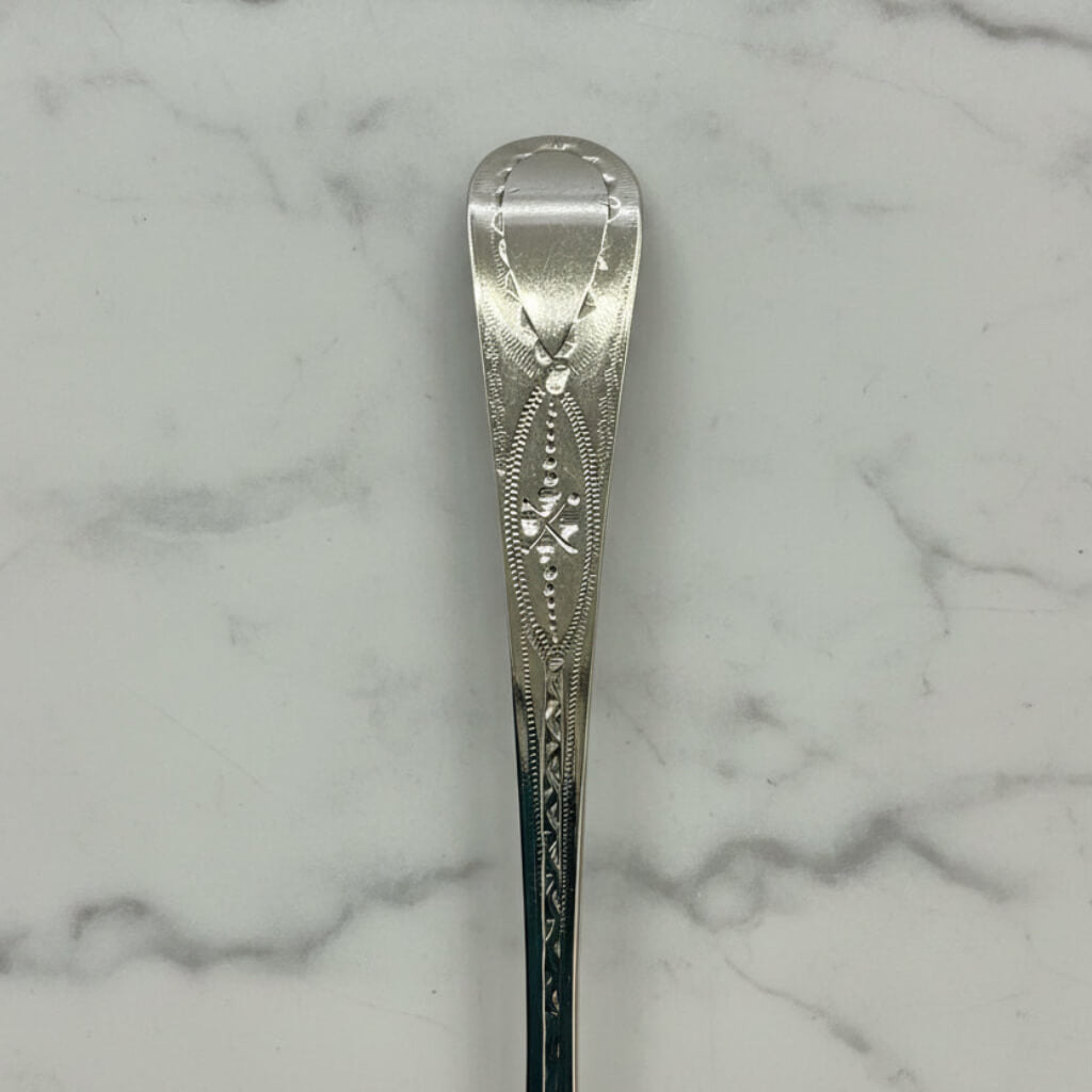 Decorative silver spoon on a marble surface