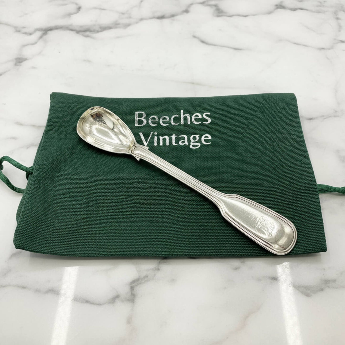 Antique 1835 Sterling Silver Mustard Spoon on a green bagon marble