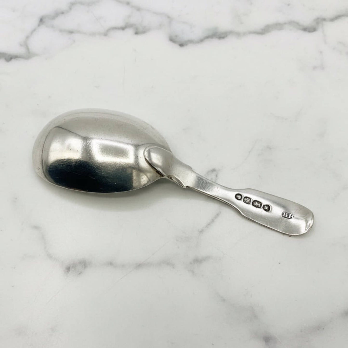 Silver spoon on a marble surface