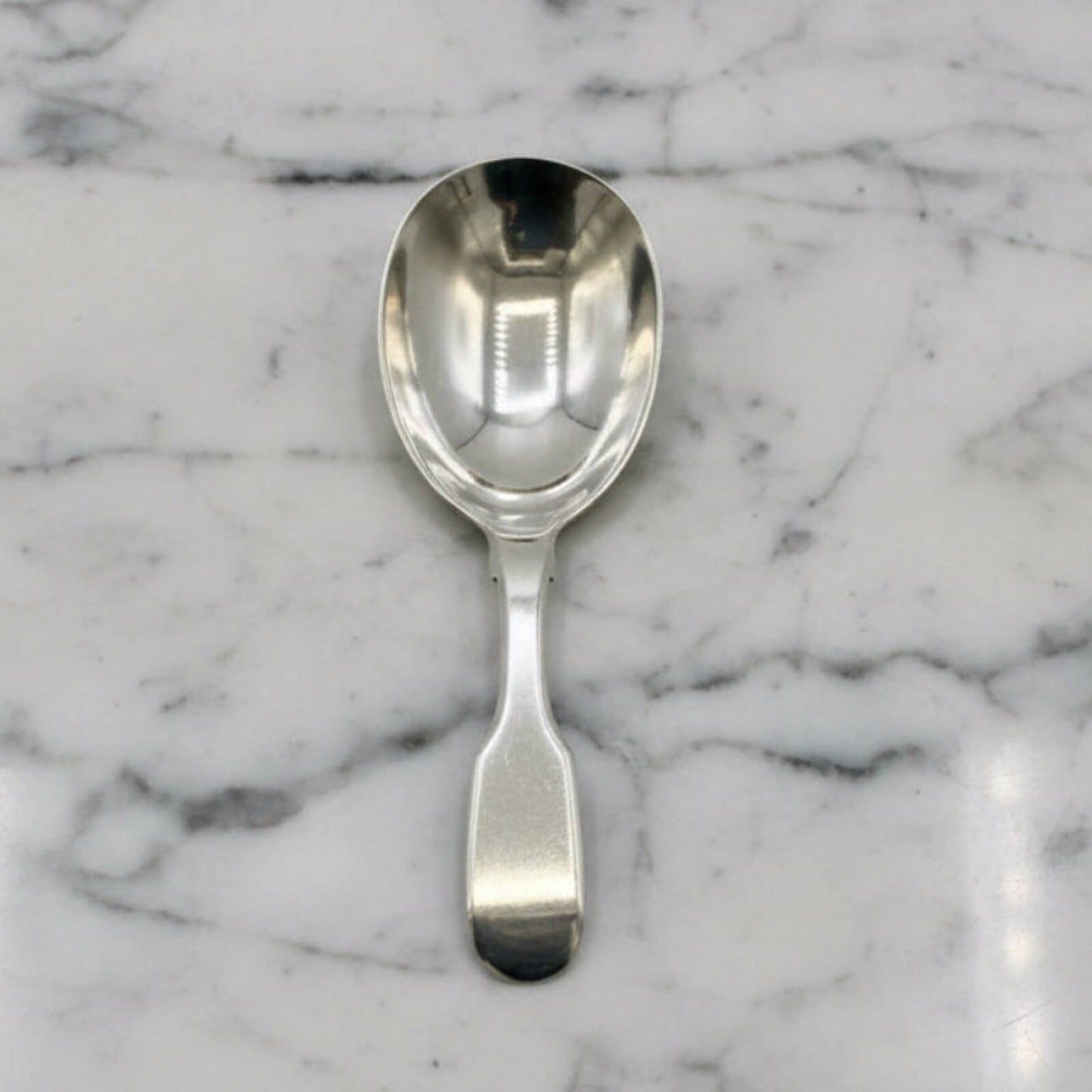 Silver spoon on a marble surface