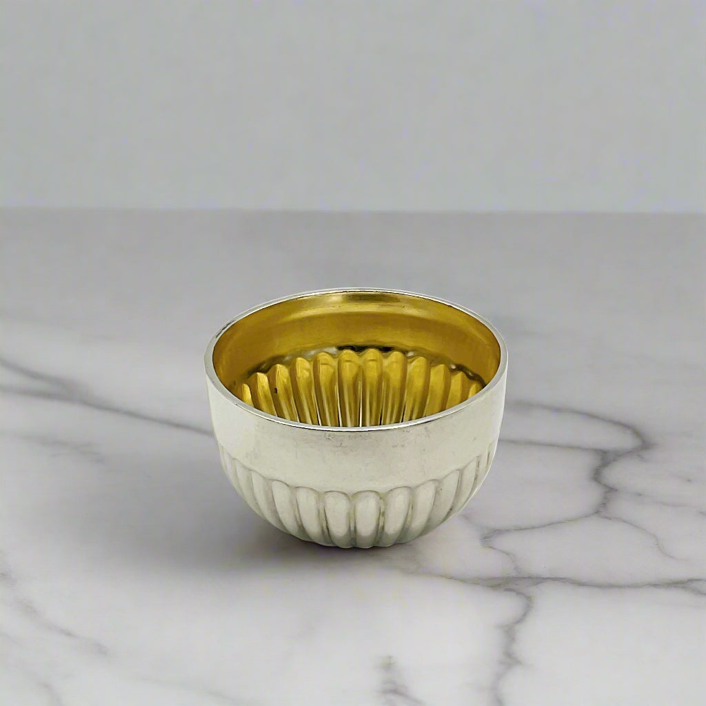 Glided silver Victorian salt on a marble worktop