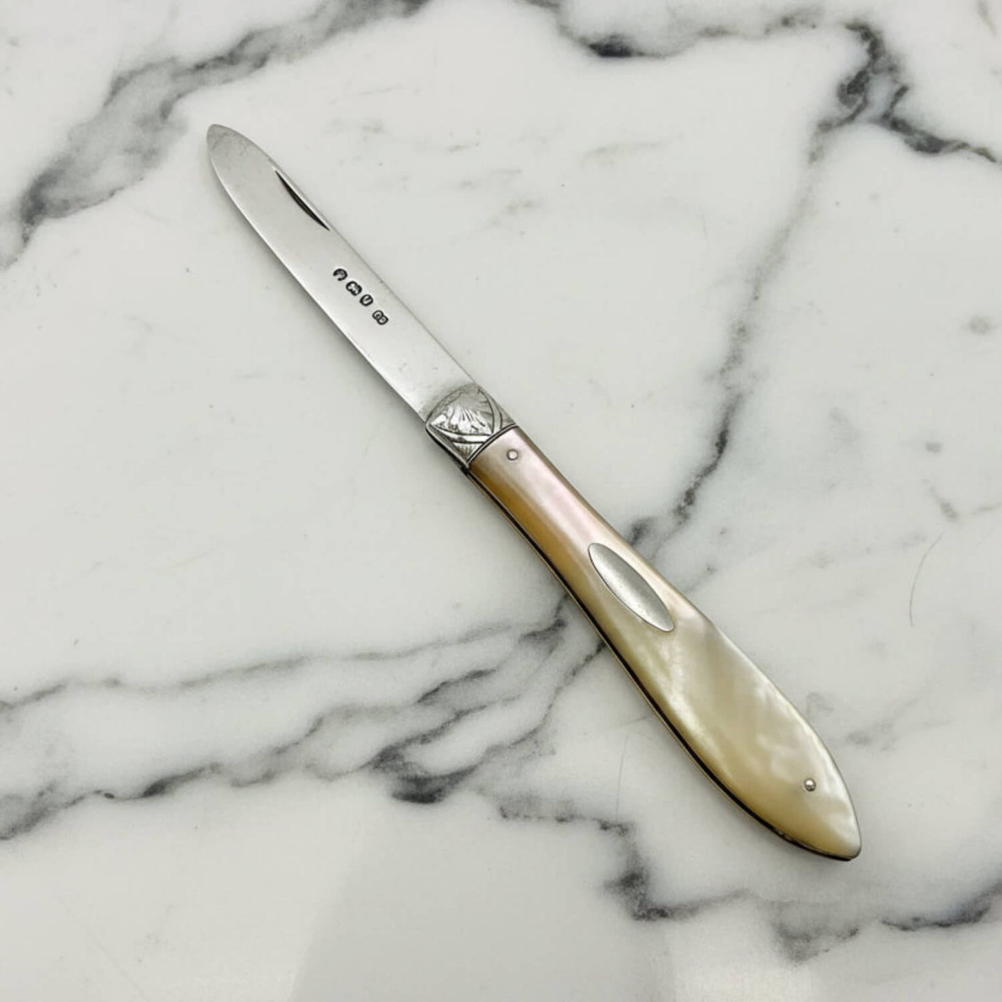 Decorative knife with a decorative handle on a marble surface