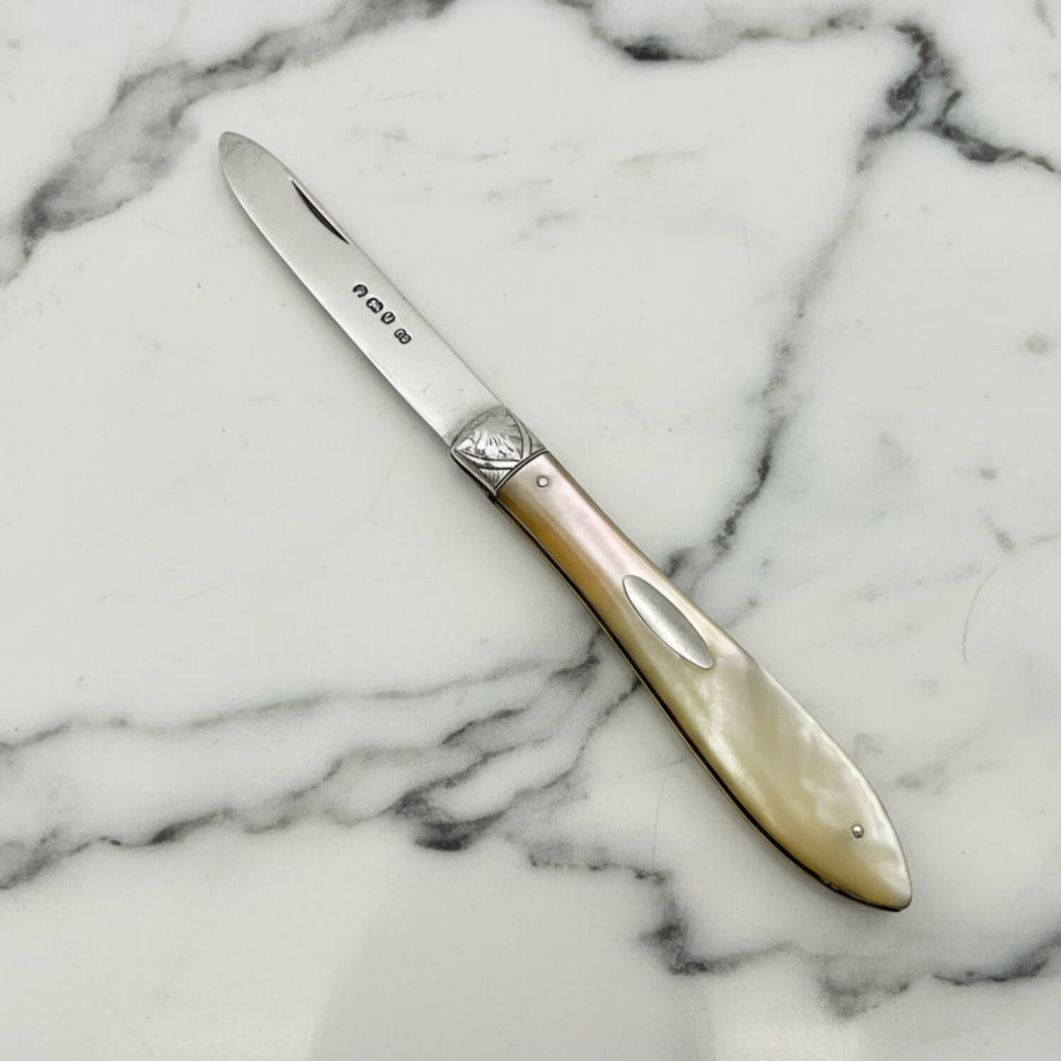 Decorative knife with a decorative handle on a marble surface