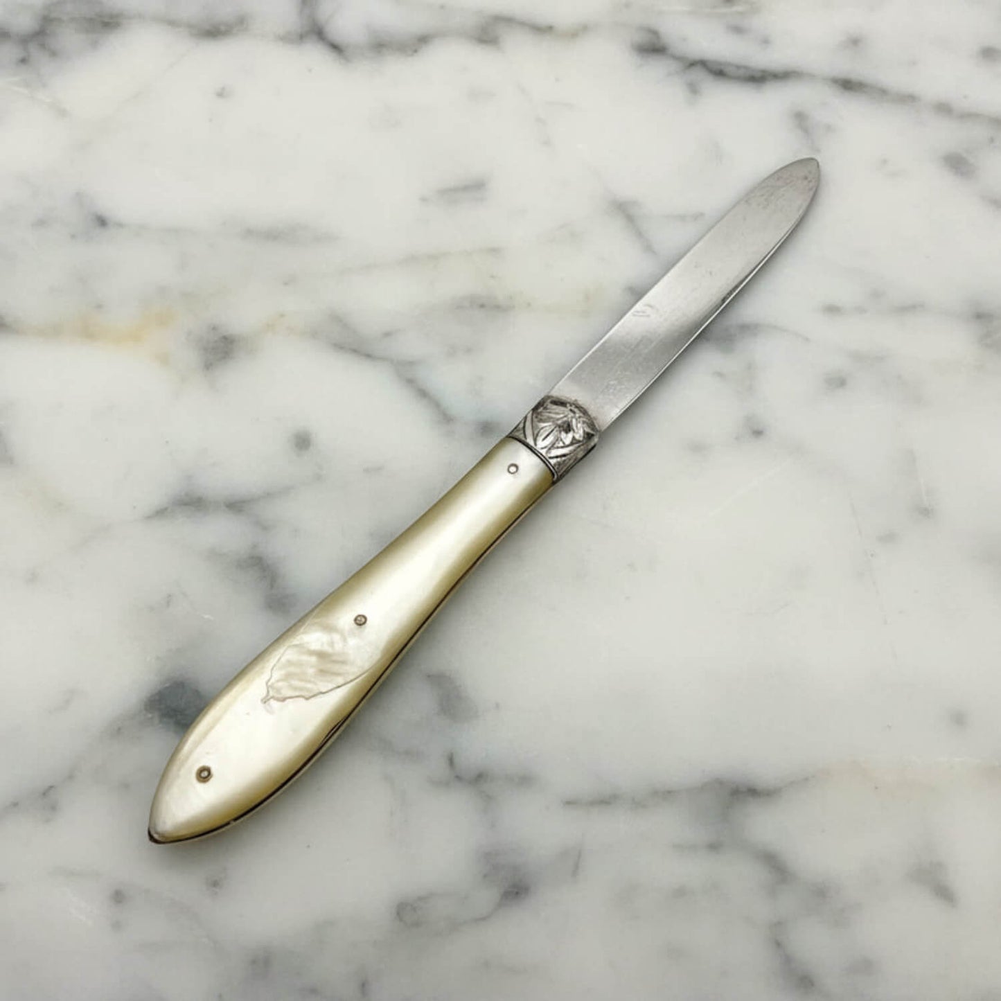 Decorative knife with a decorative handle on a marble surface