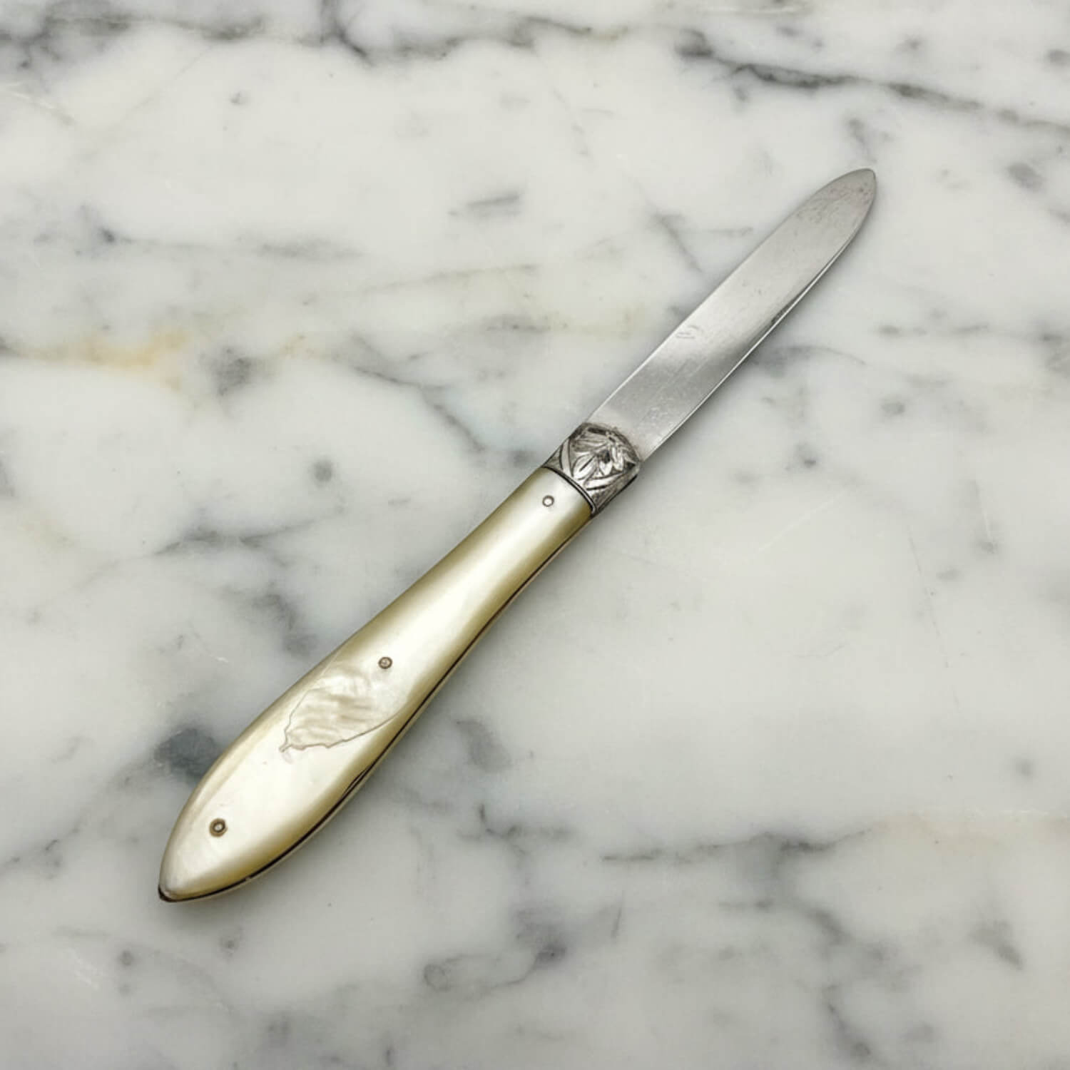 Decorative knife with a decorative handle on a marble surface