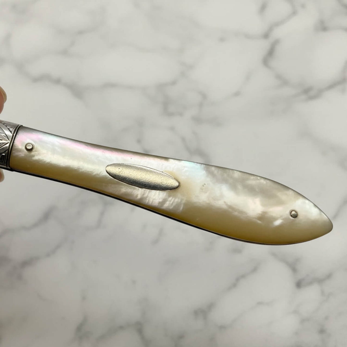 Decorative knife with a decorative handle on a marble background