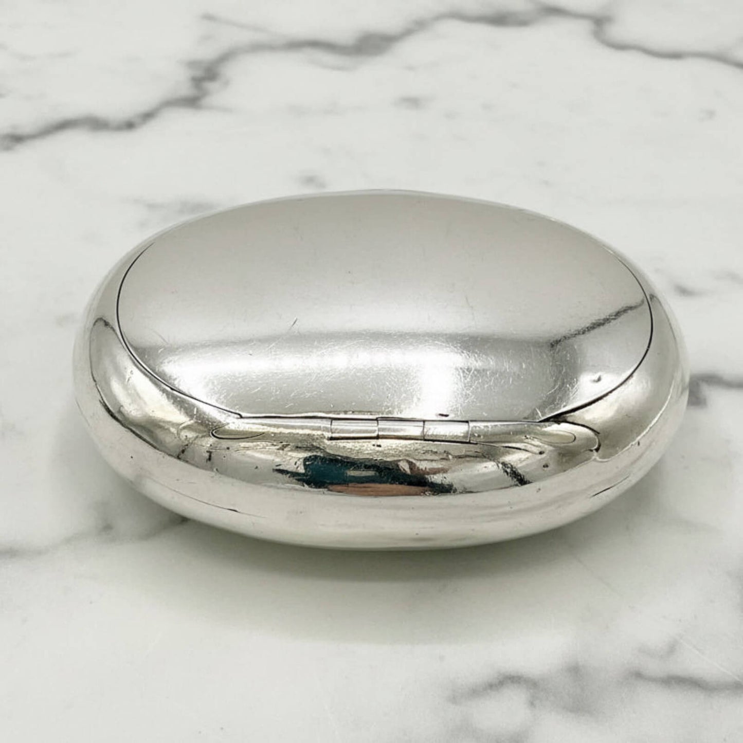 Silver box on a marble surface
