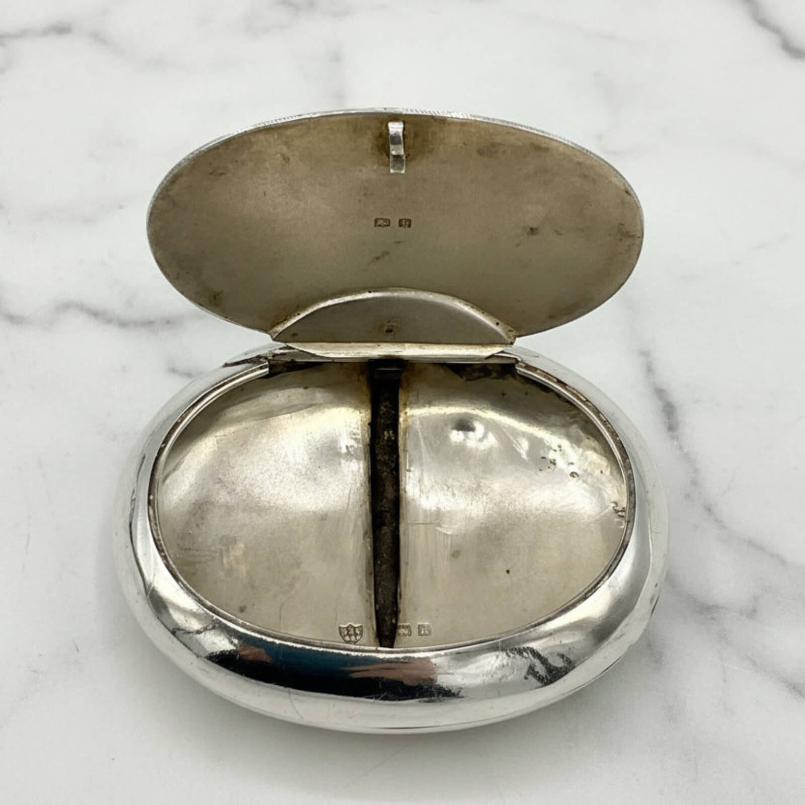 Silver box on a marble surface