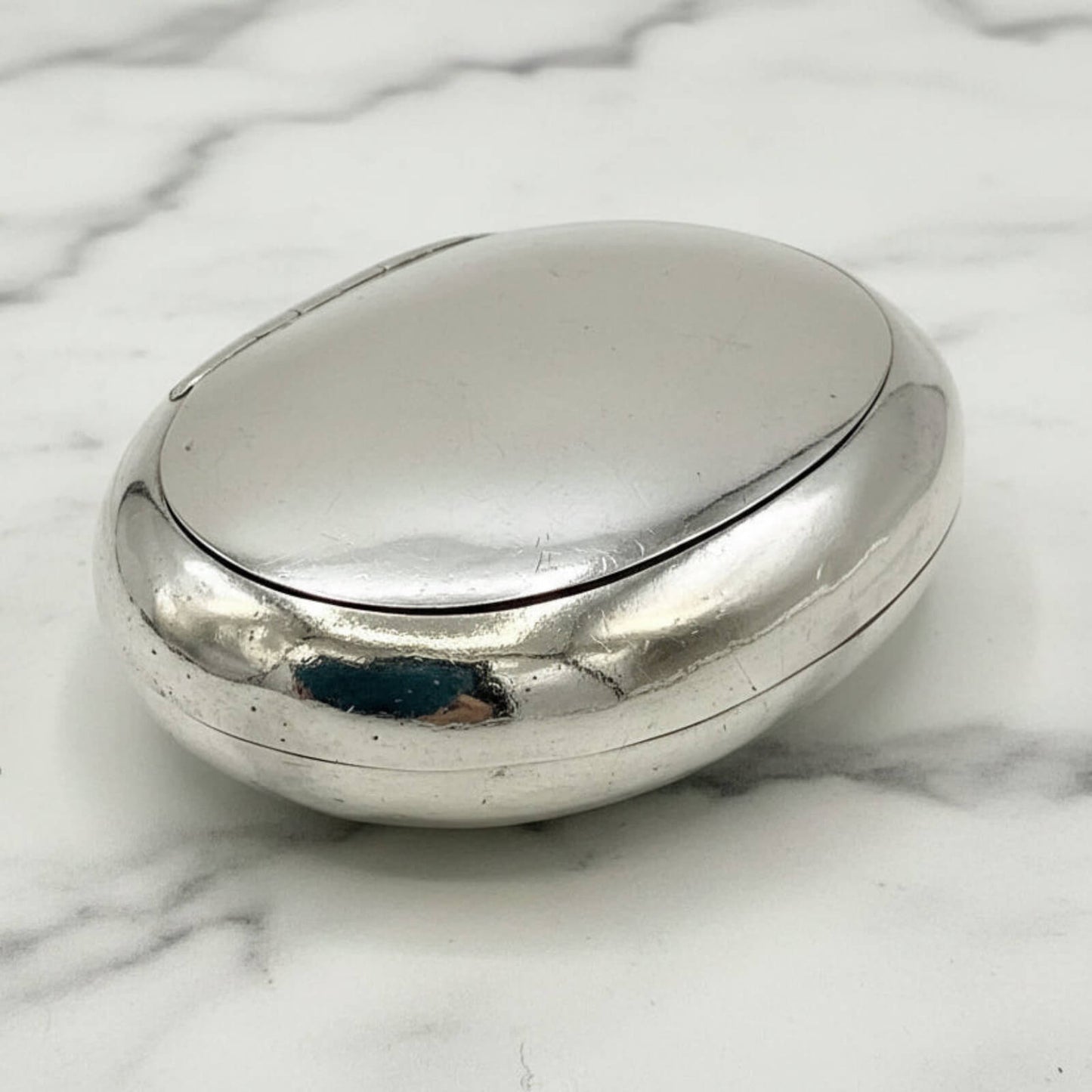 Silver box on a marble surface