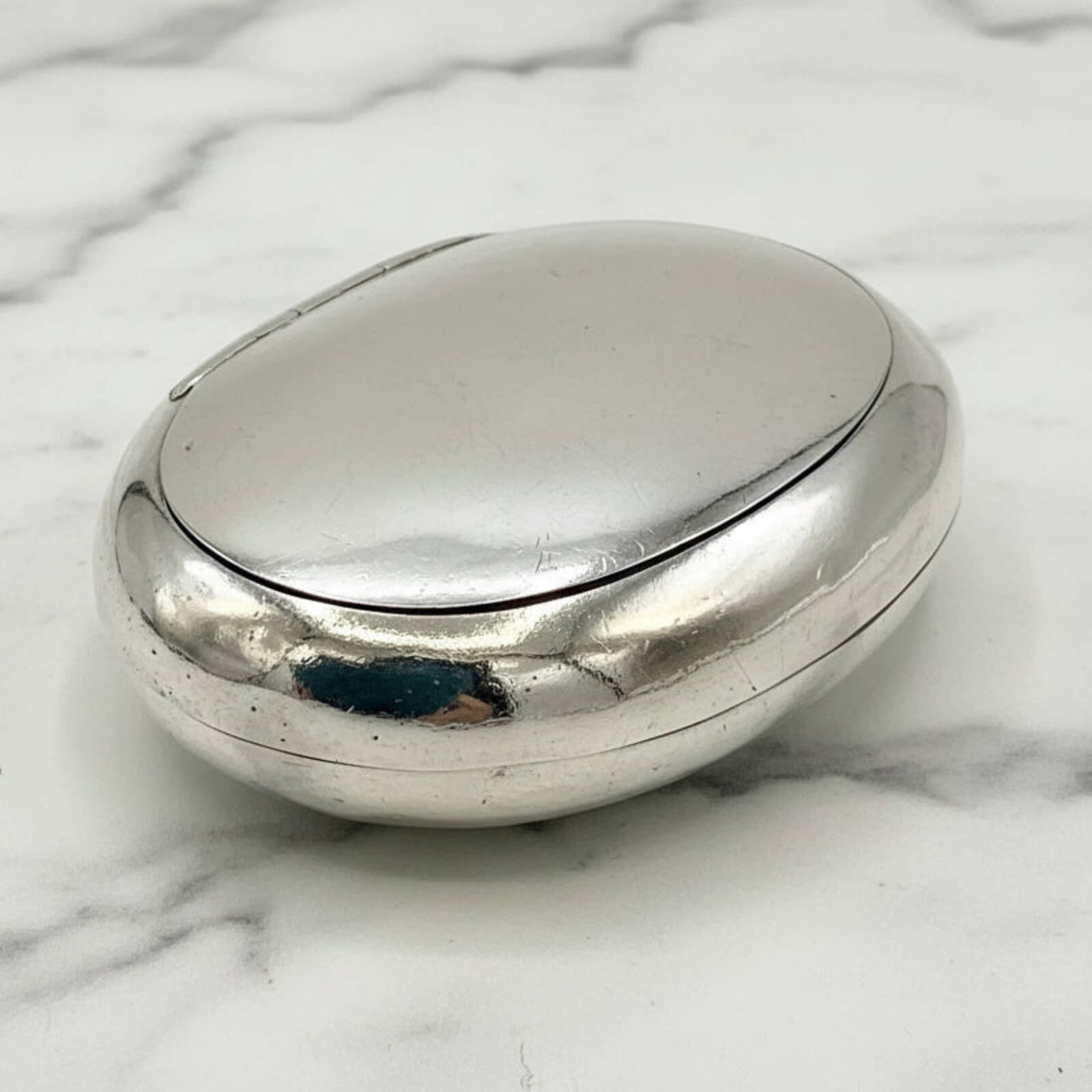 Silver box on a marble surface