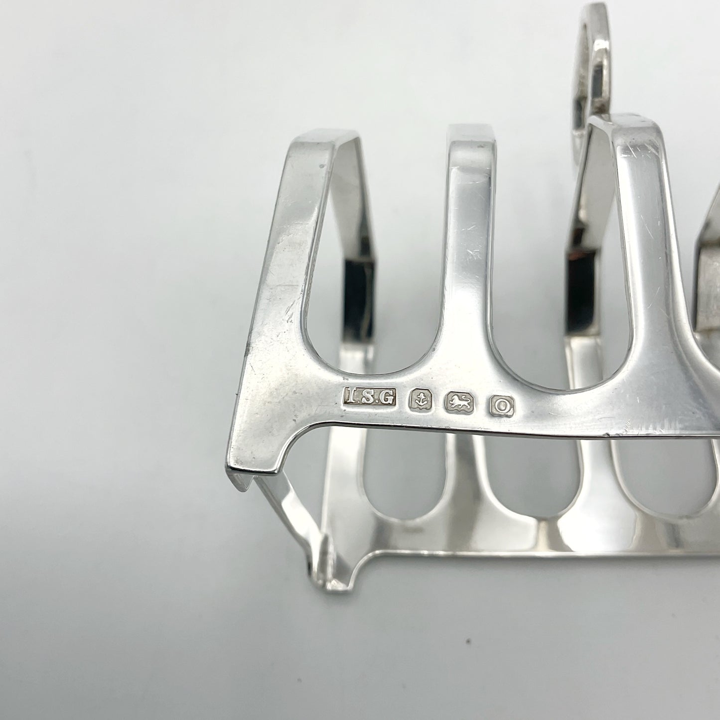 Silver hallmarks for Birmingham 1913 on a silver toast rack