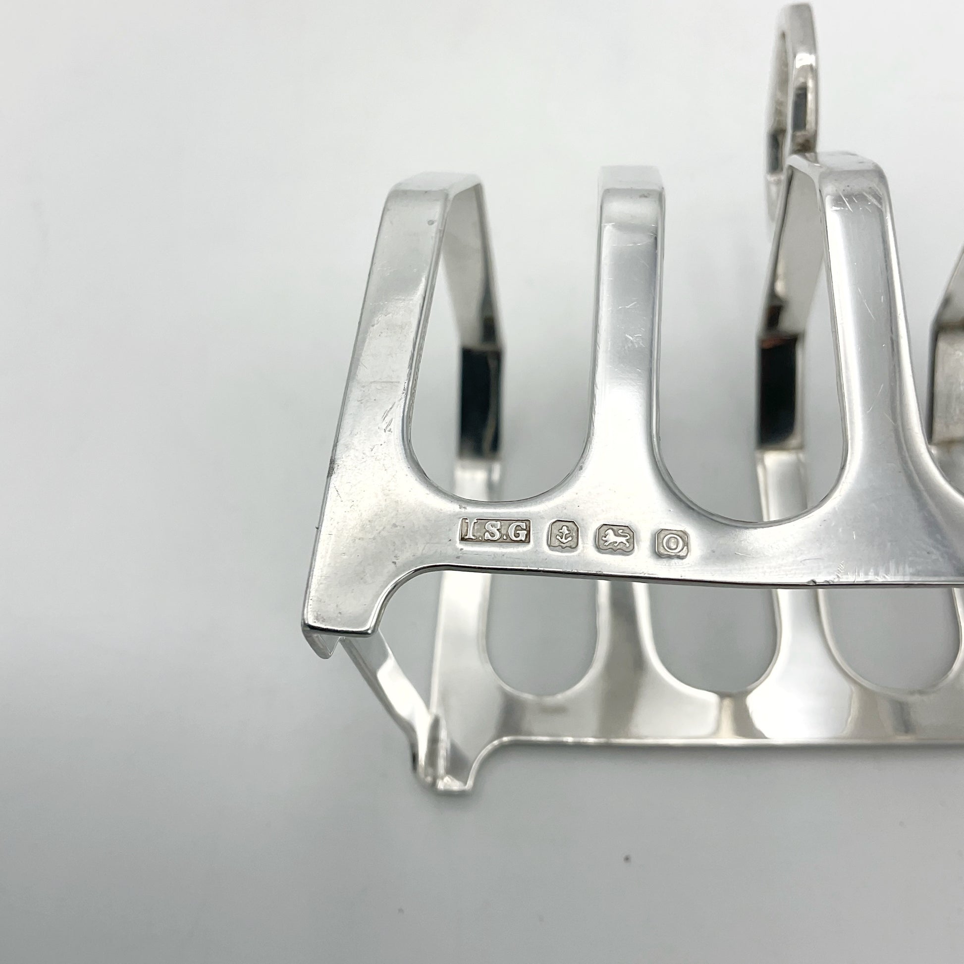 Silver hallmarks for Birmingham 1913 on a silver toast rack