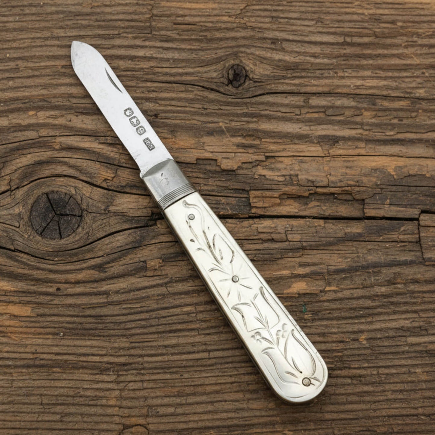 Antique 1922 Sterling Silver Fruit Knife on a wood bench