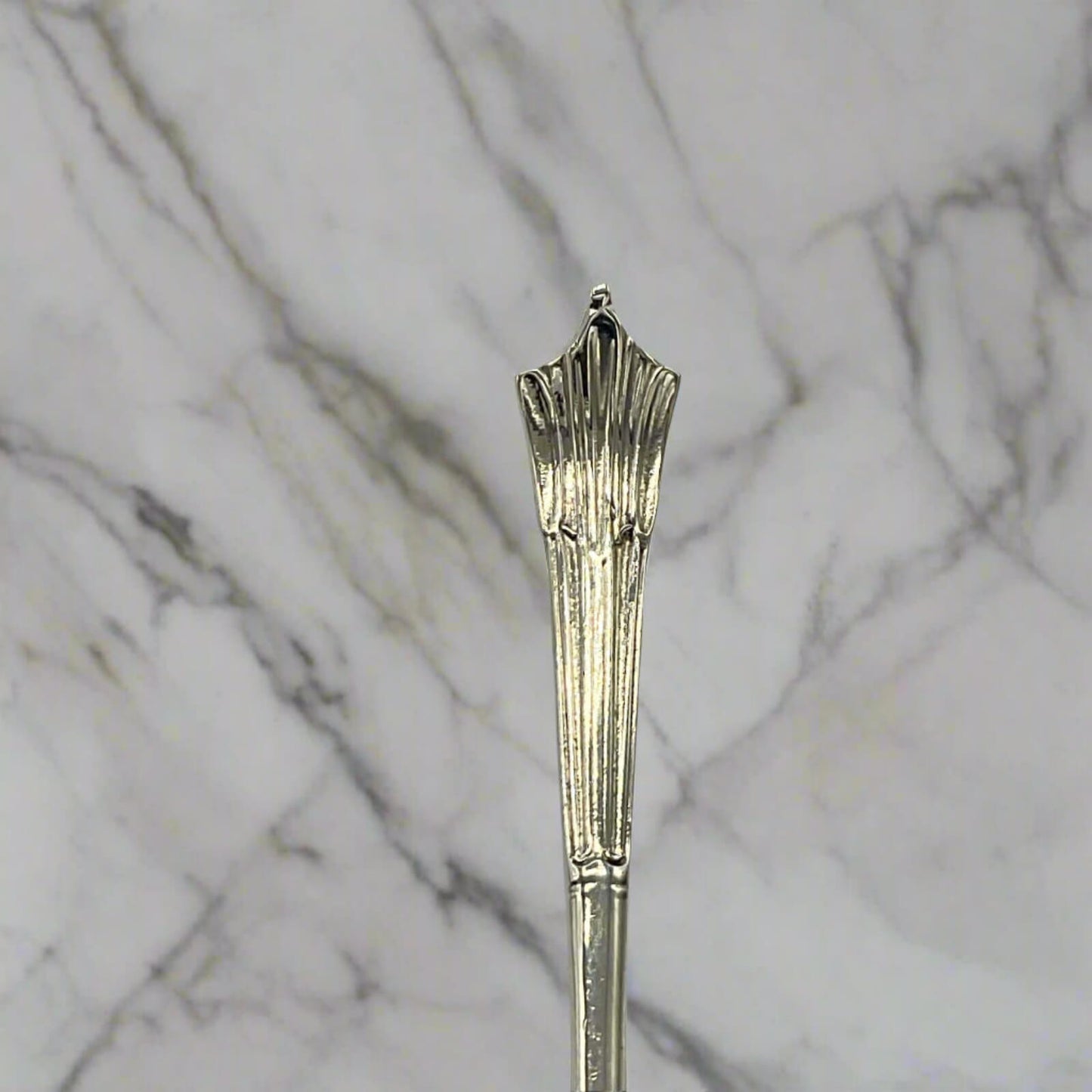 Decorative silver spoon on a marble background