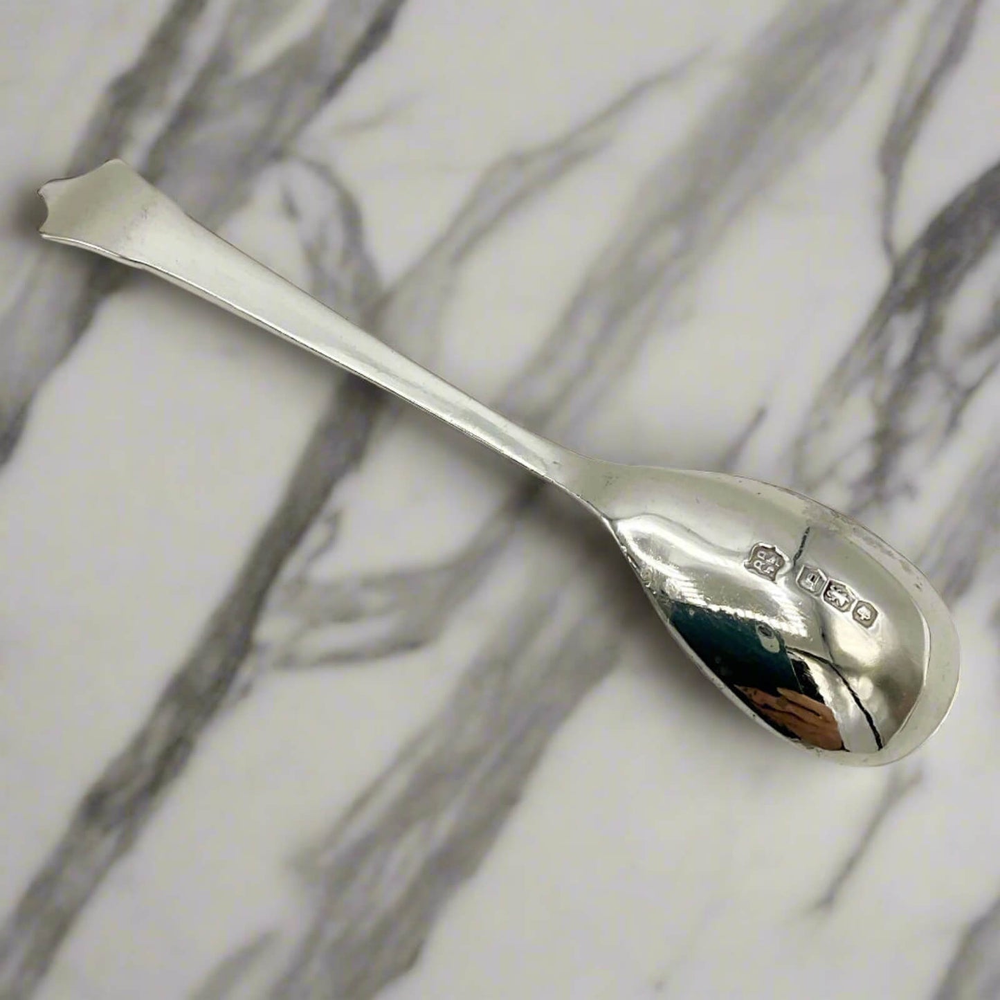 Silver spoon on a marble surface