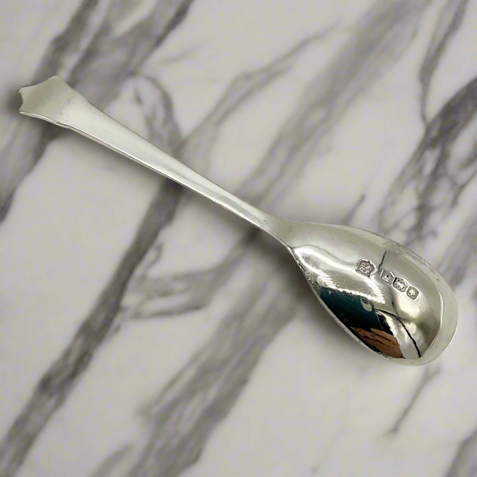Silver spoon on a marble surface