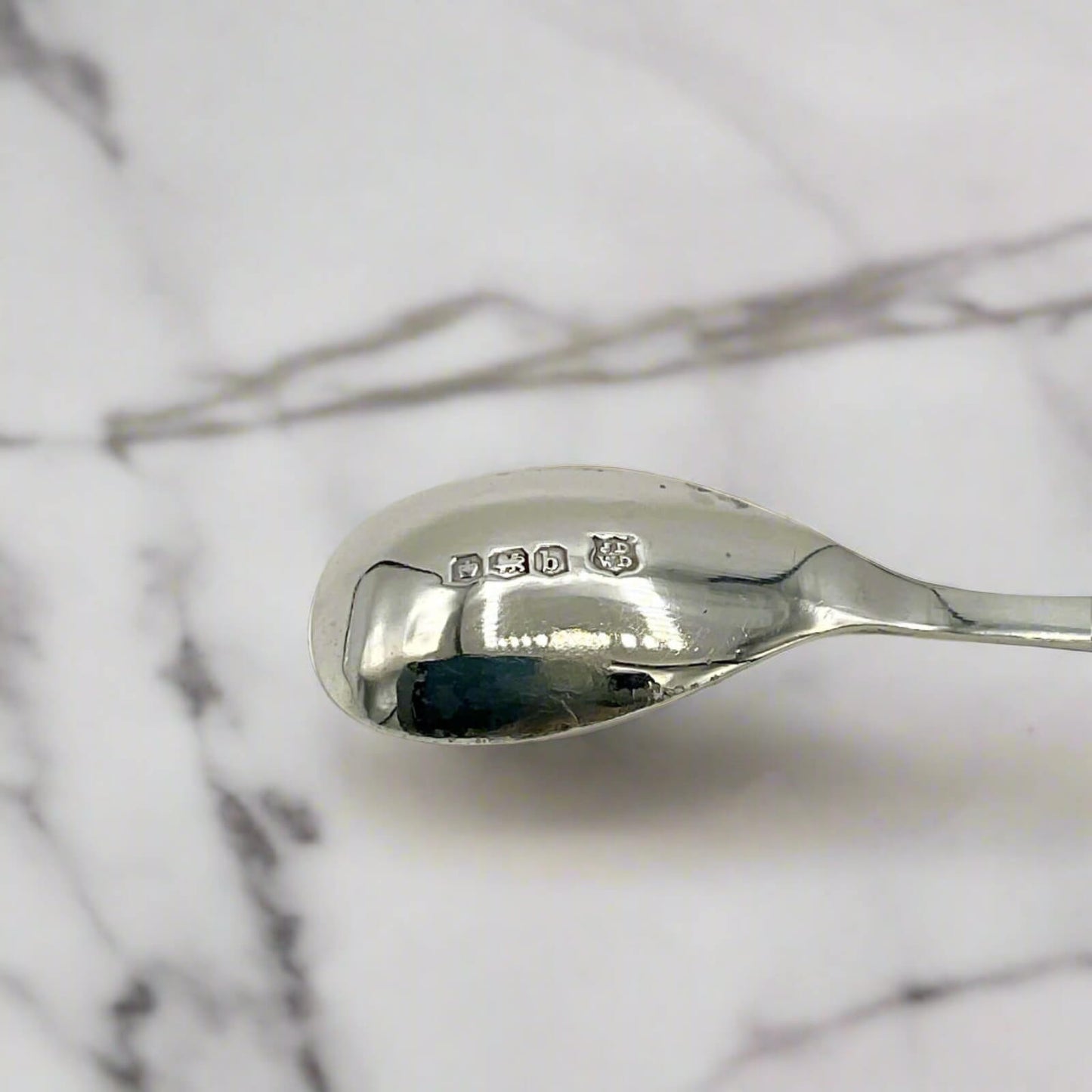 Silver spoon on a marble surface