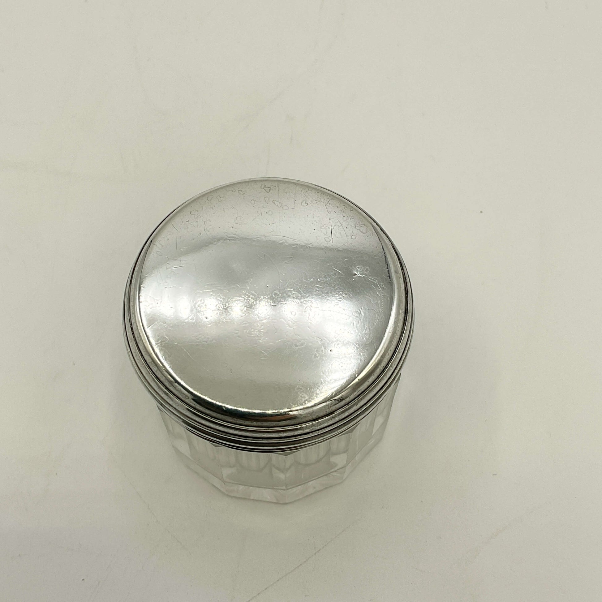 Silver jar with a lid on a white background