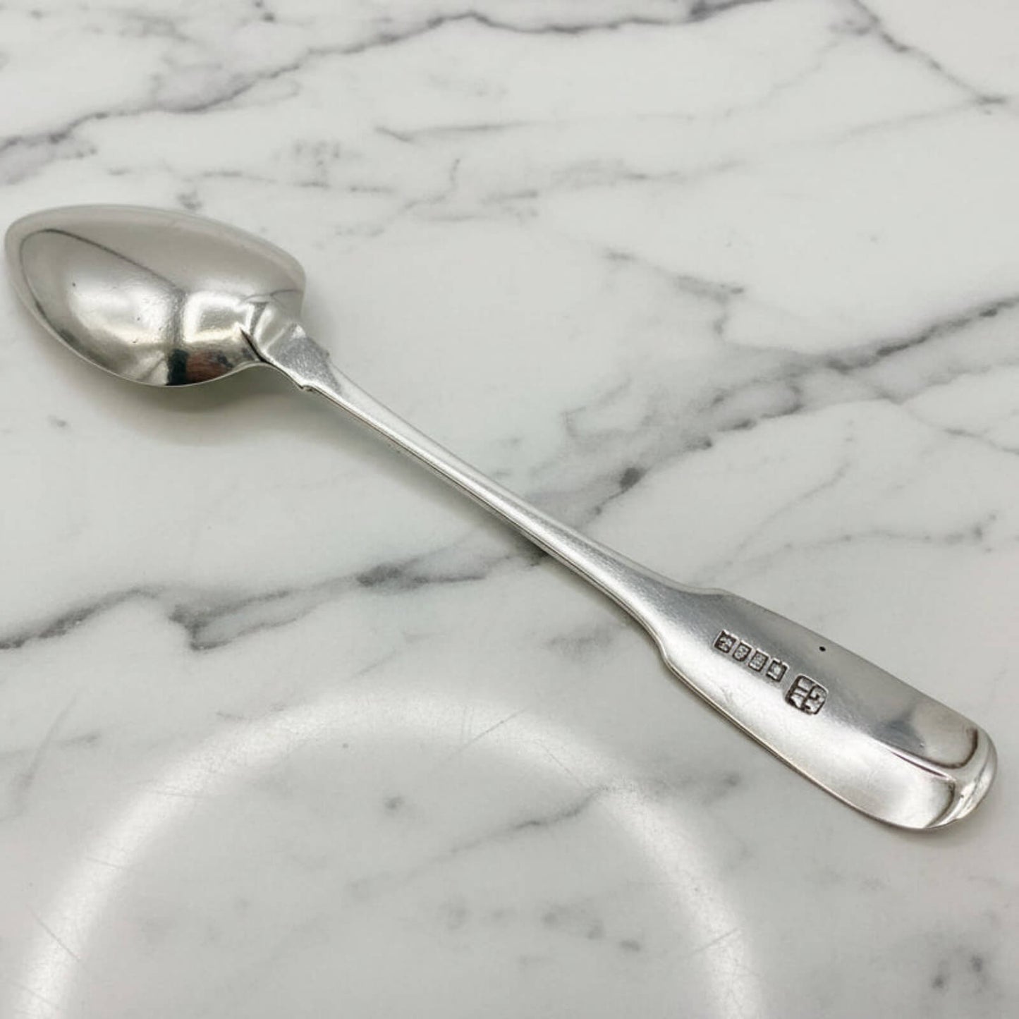 Silver spoon on a marble surface