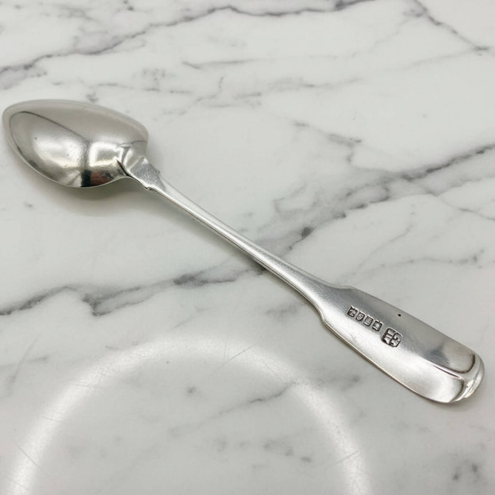 Silver spoon on a marble surface