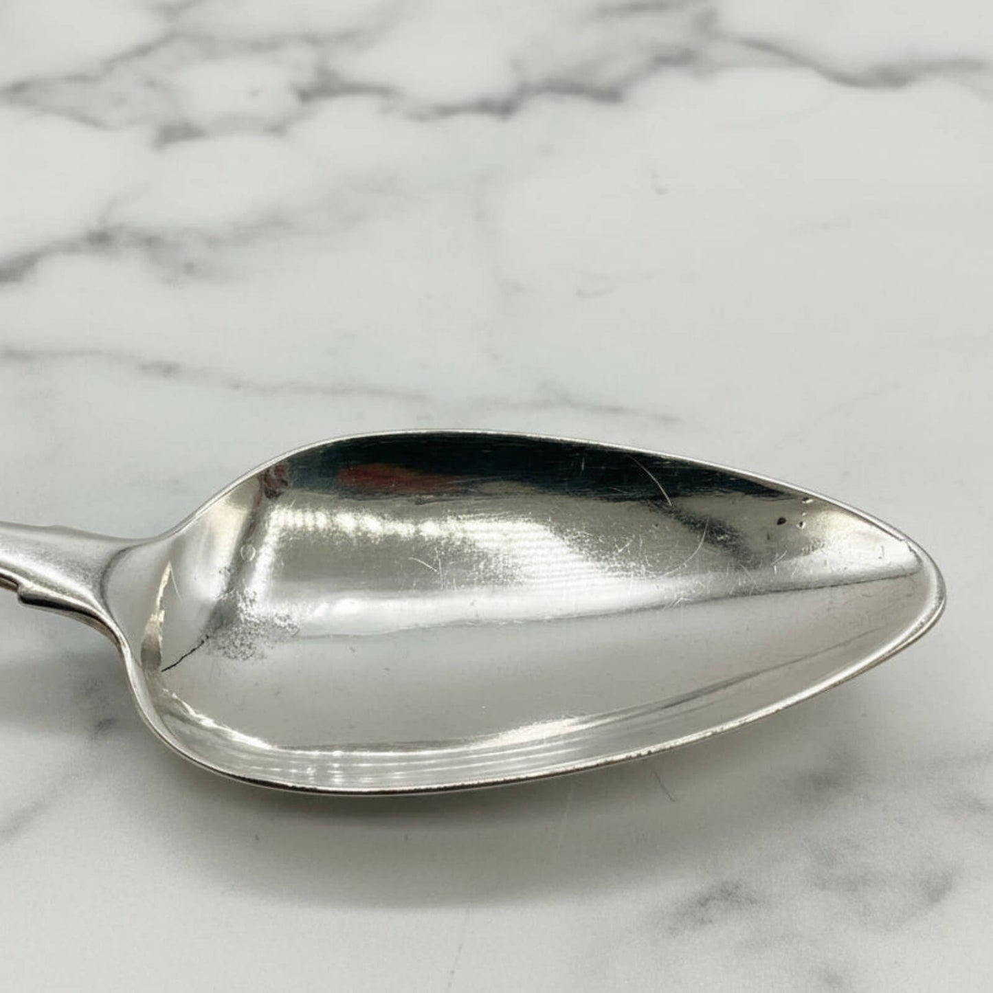 Silver spoon on a marble surface