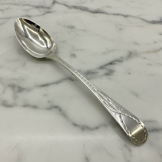 Antique Georgian Sterling Silver Teaspoon, Hallmarked 1793 on a marble surface