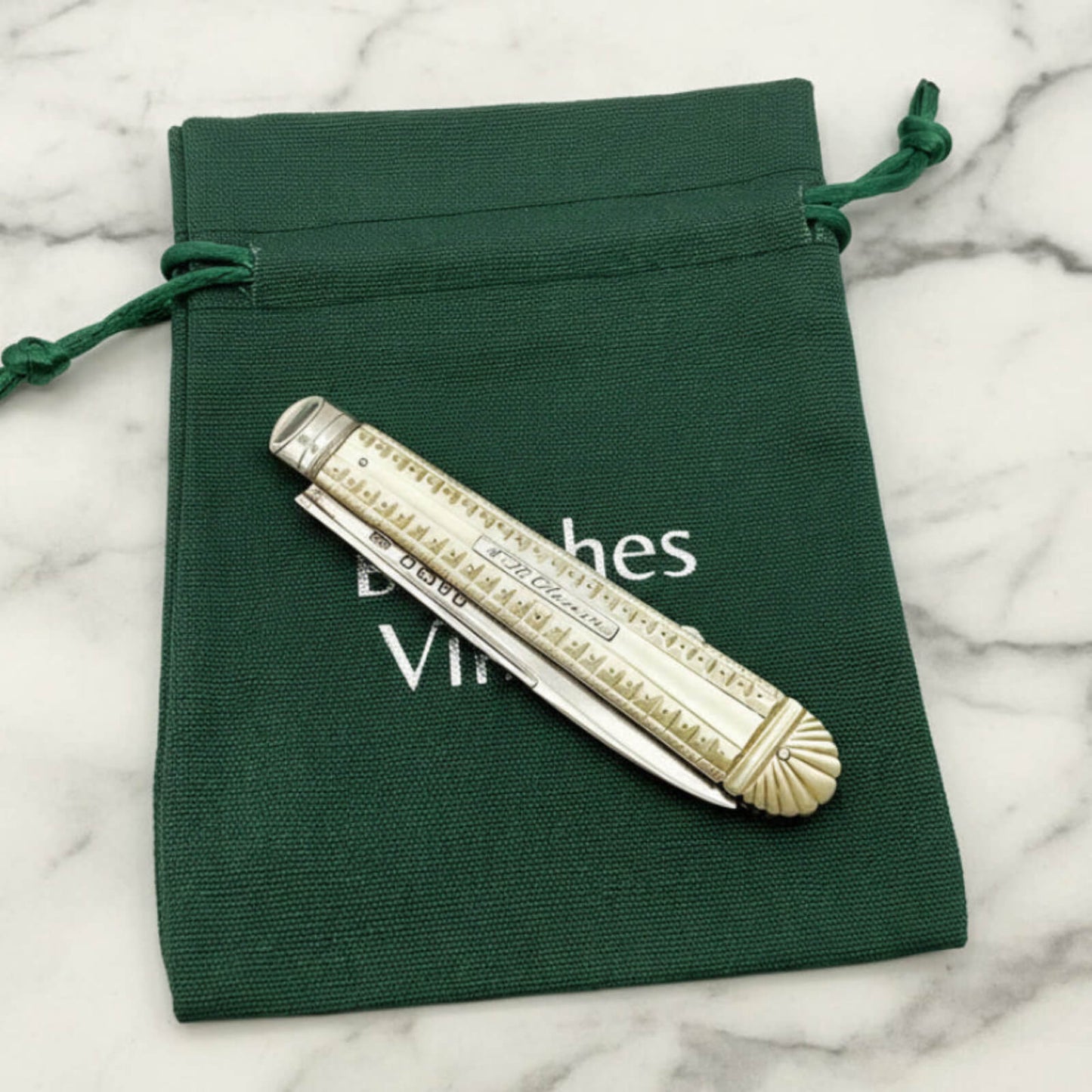 fruit knife on a green bag on a marble surface