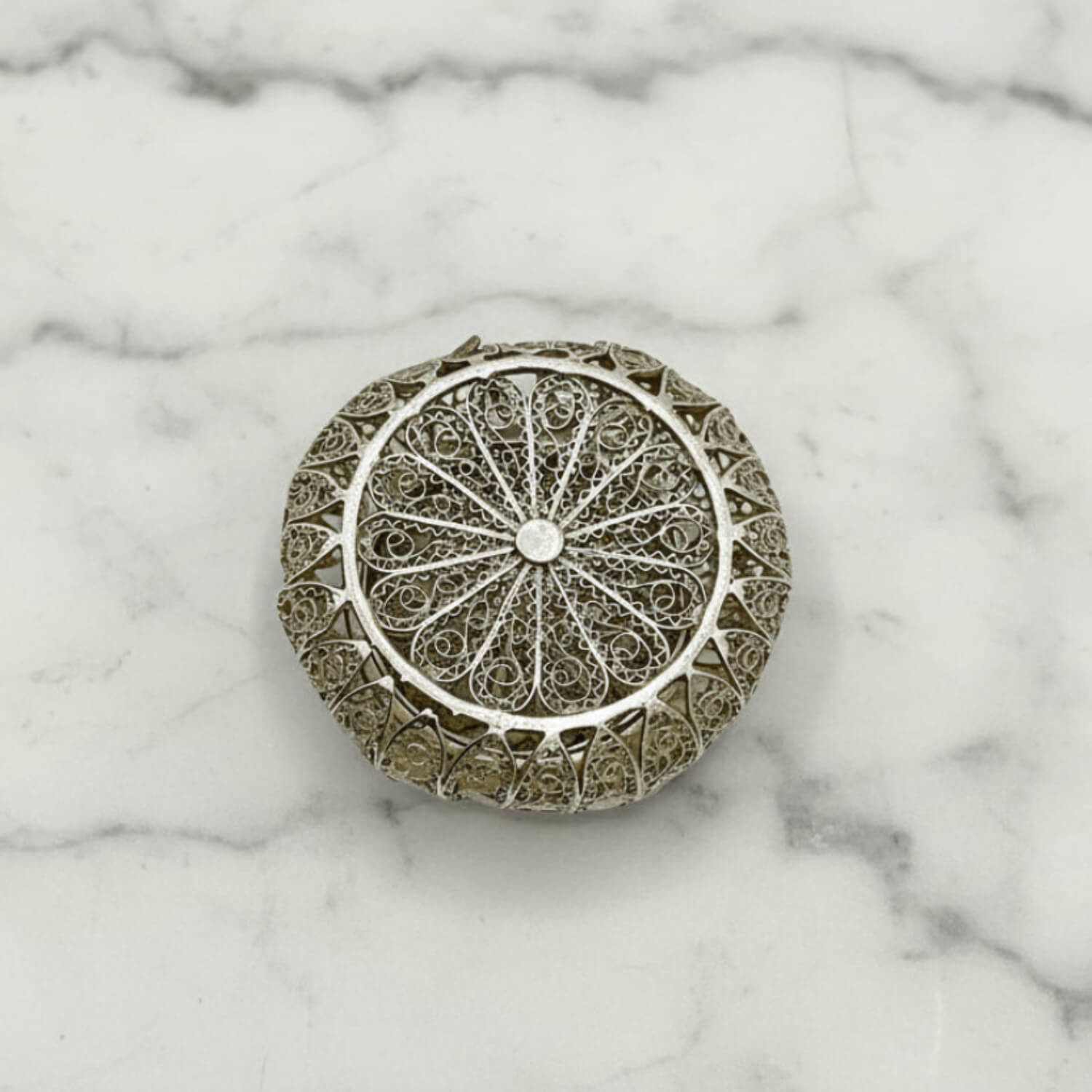 Antique Silver Filigree Box base on a marble surface