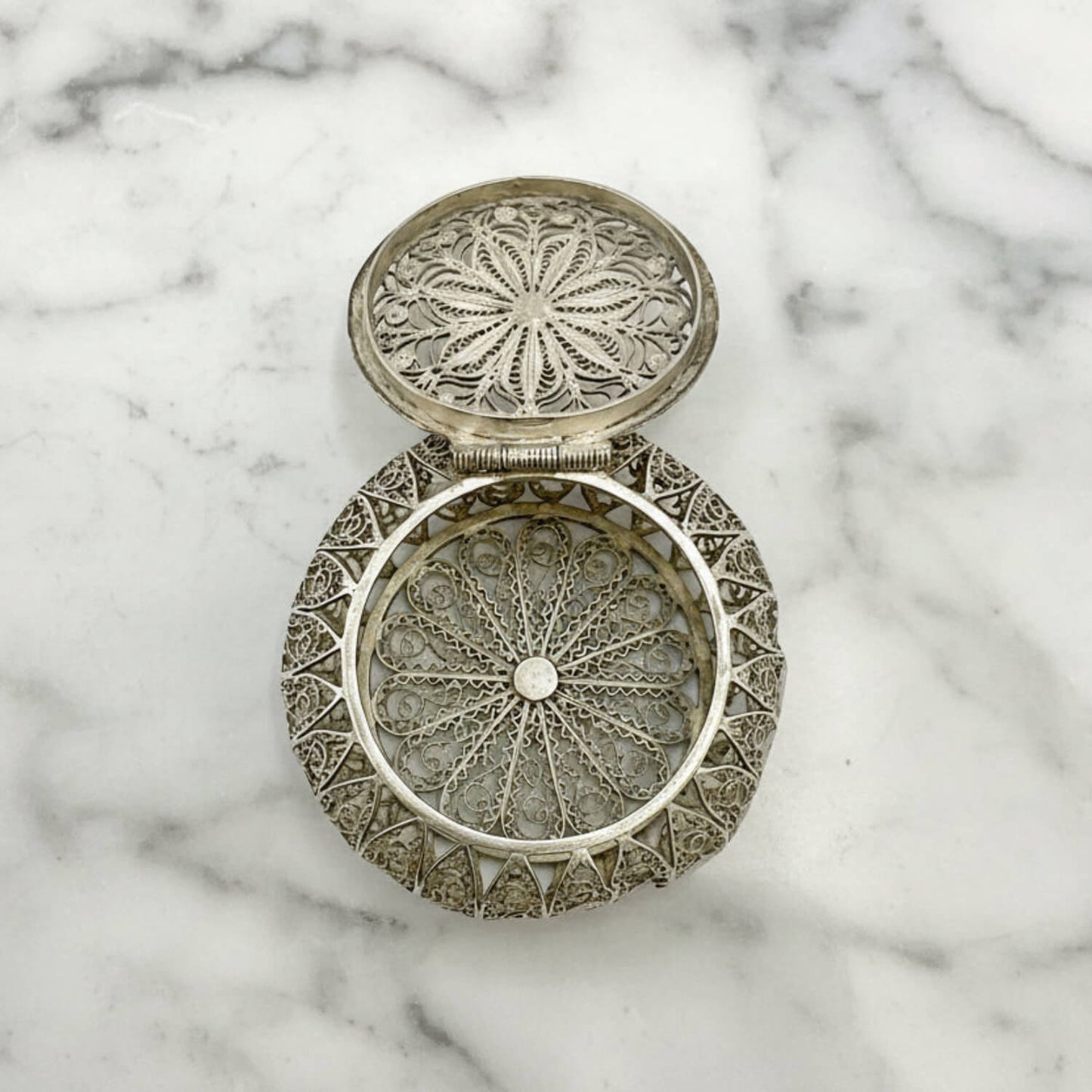 Antique Silver Filigree Box on a marble background