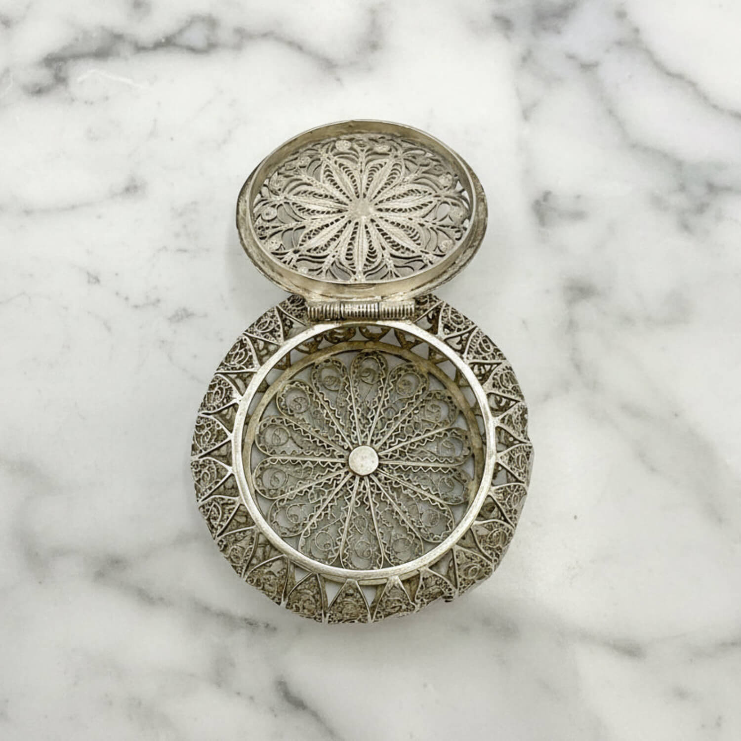 Antique Silver Filigree Box on a marble background