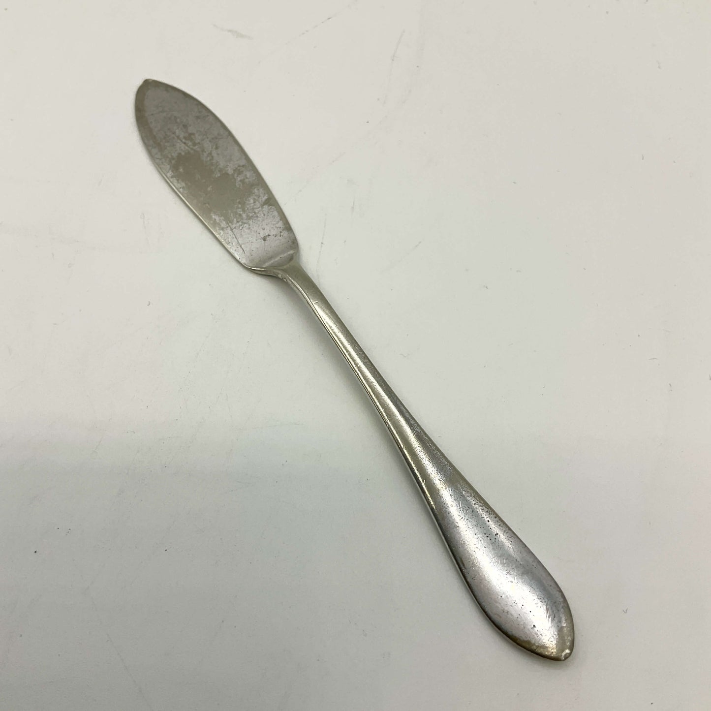 Silver butter knife on a white background