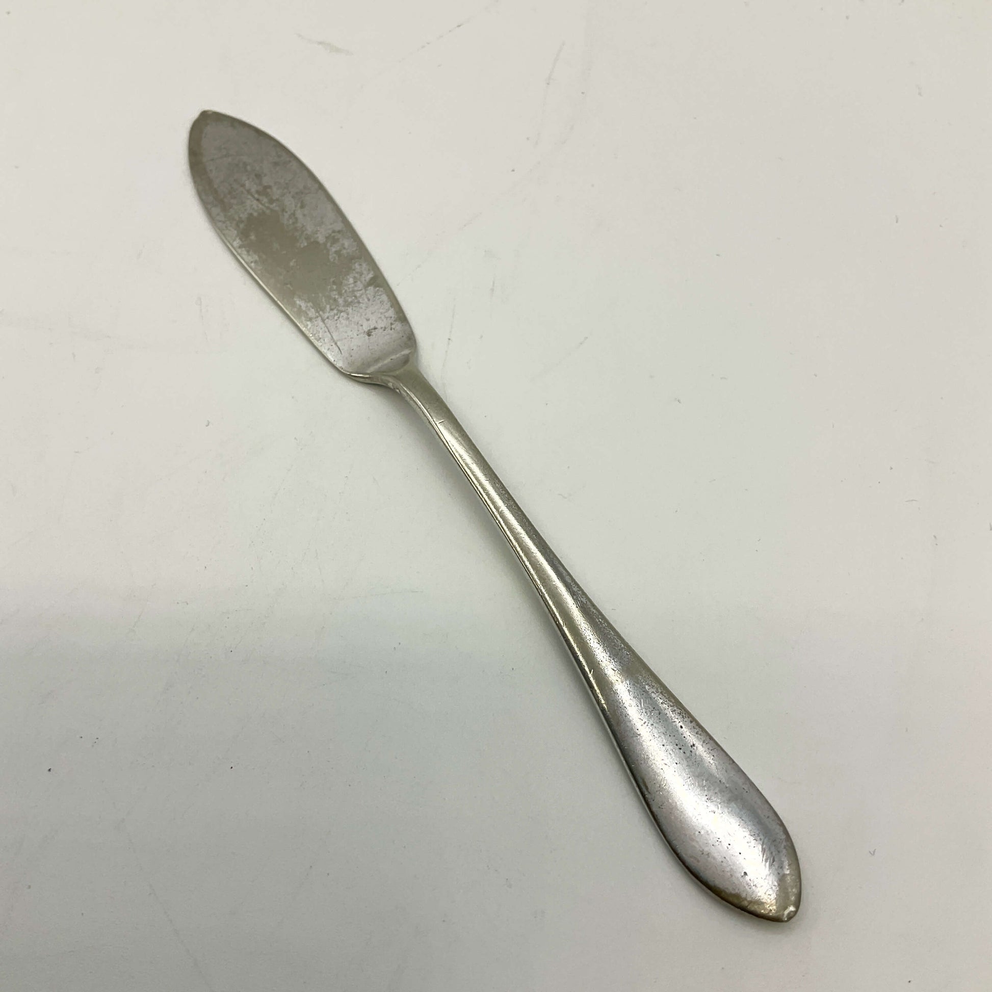 Silver butter knife on a white background