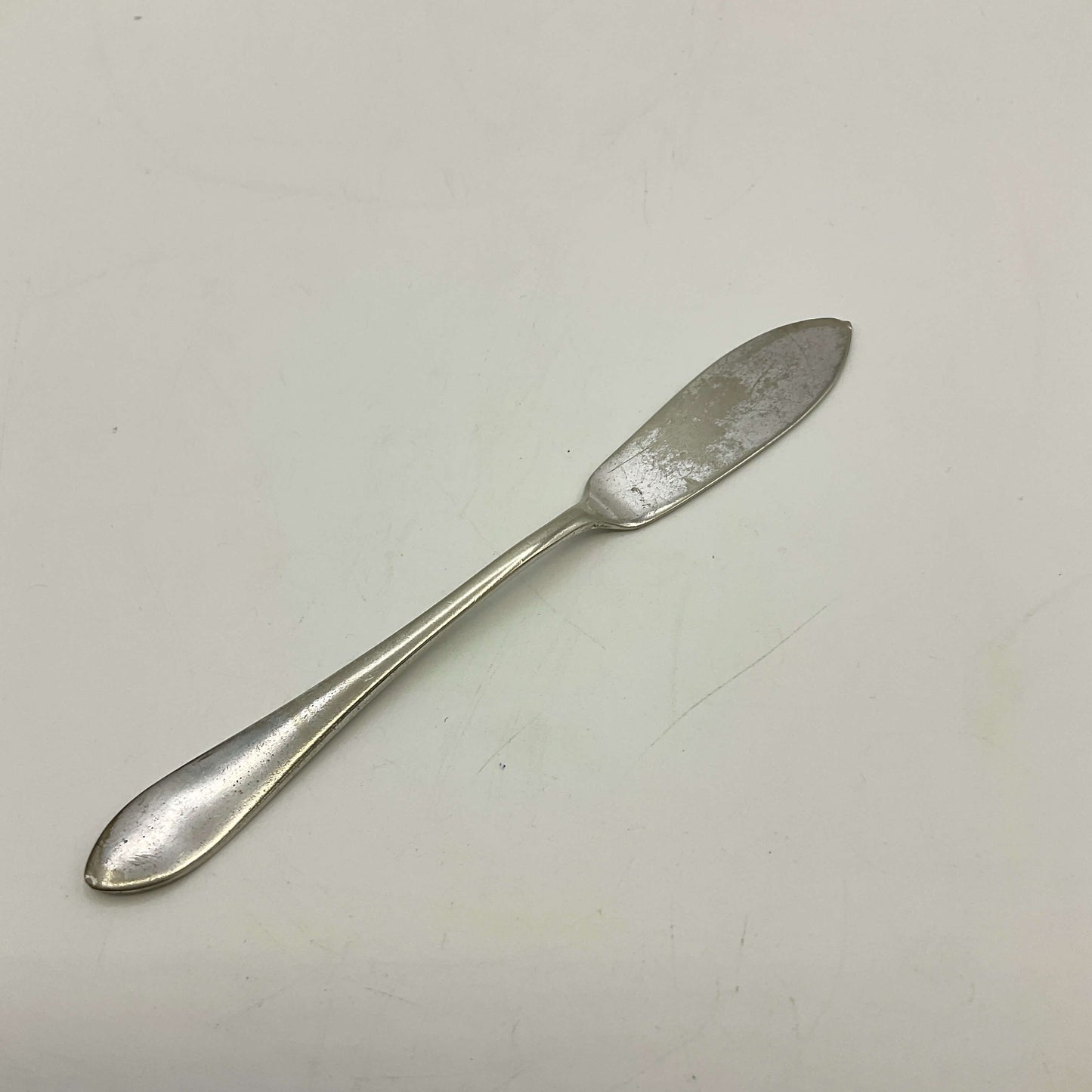 Silver butter knife on a white background