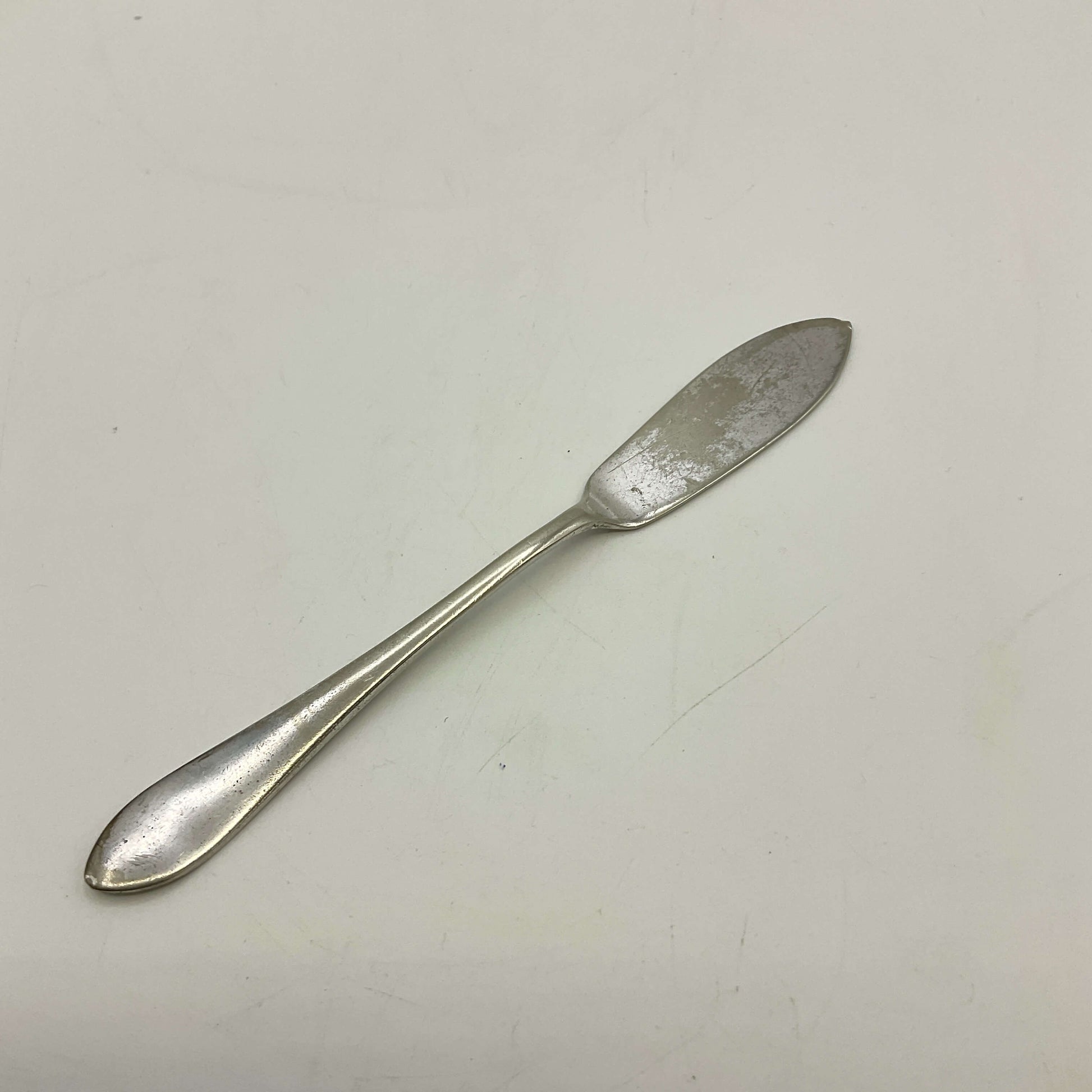 Silver butter knife on a white background