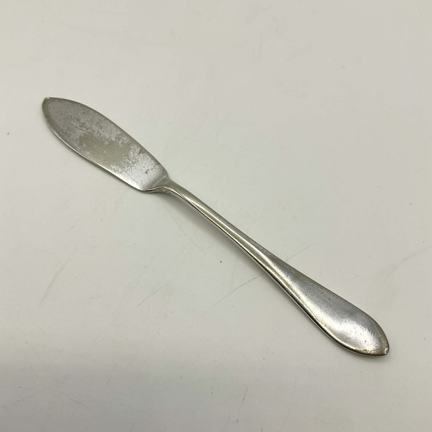 Silver butter knife on a white background