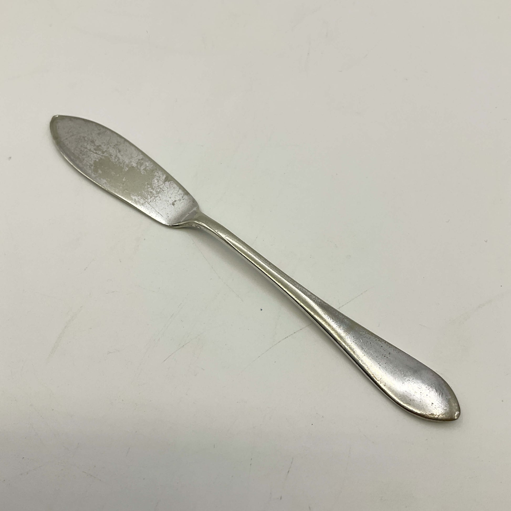 Silver butter knife on a white background