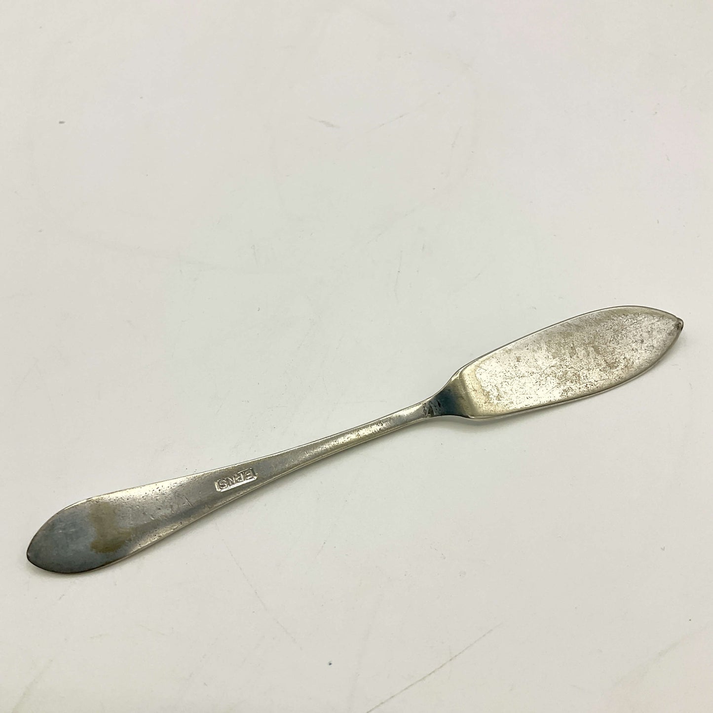 Silver butter knife on a white background