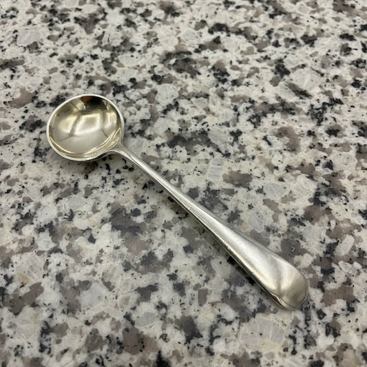 Silver spoon on a speckled granite surface