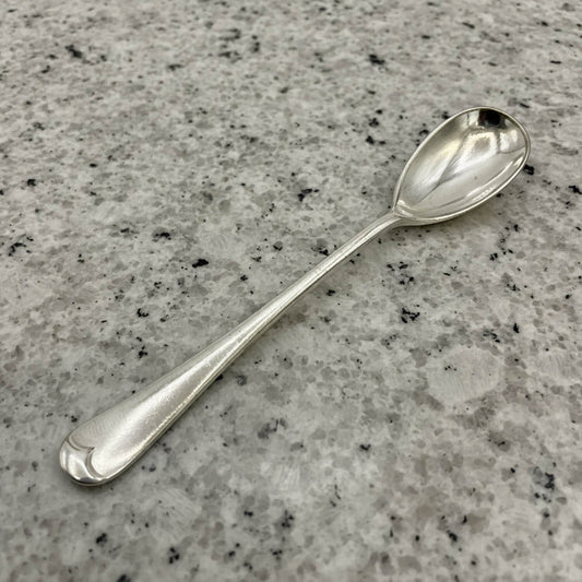 Silver spoon on a gray granite countertop