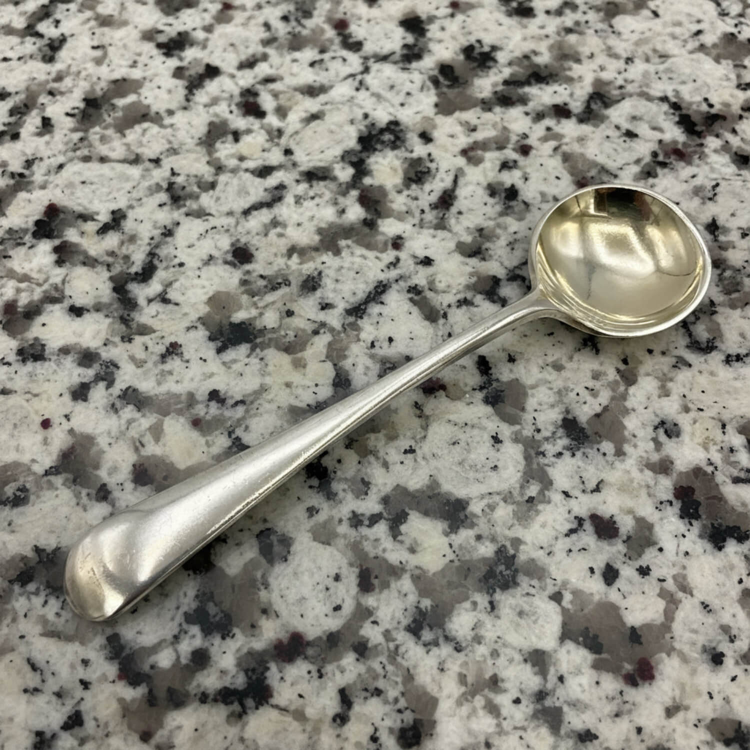 Silver spoon on a granite countertop