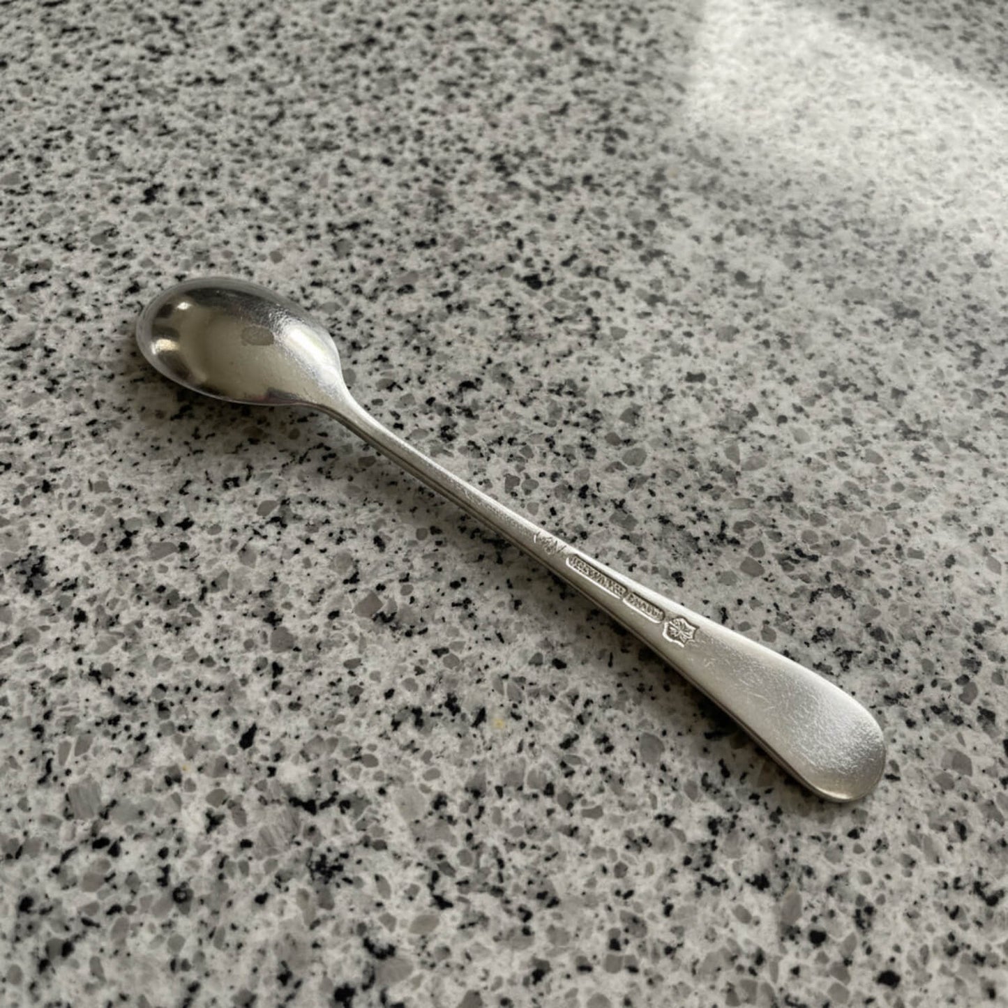 Silver spoon on a speckled gray surface