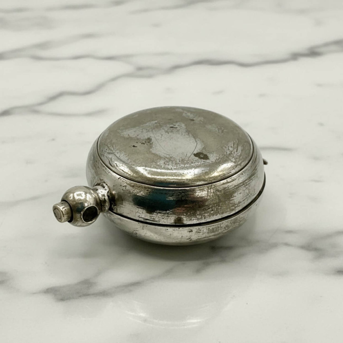 Antique Silver Plated Sovereign Case on a marble surface