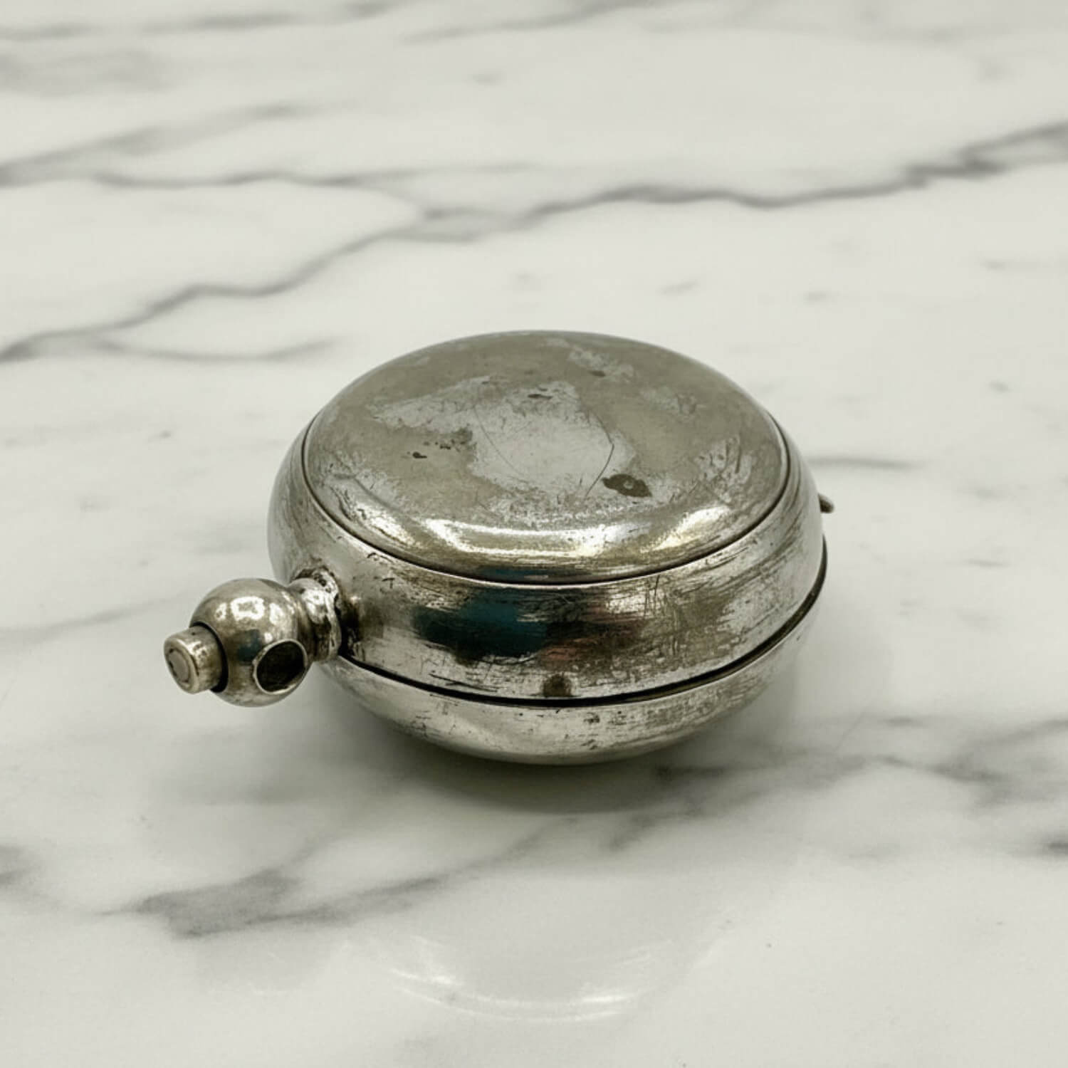 Antique Silver Plated Sovereign Case on a marble surface