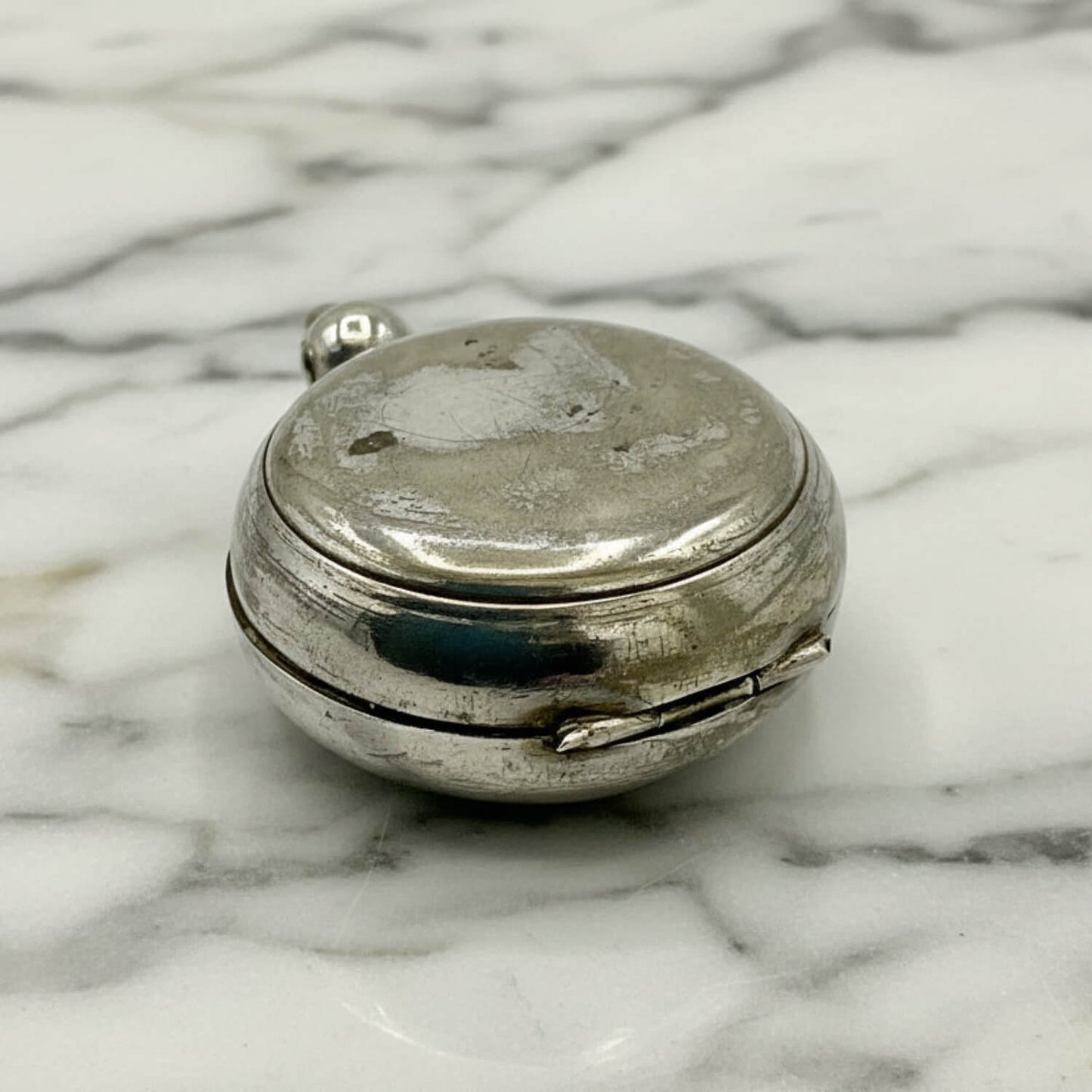 Antique Silver Plated Sovereign Case on a marble surface