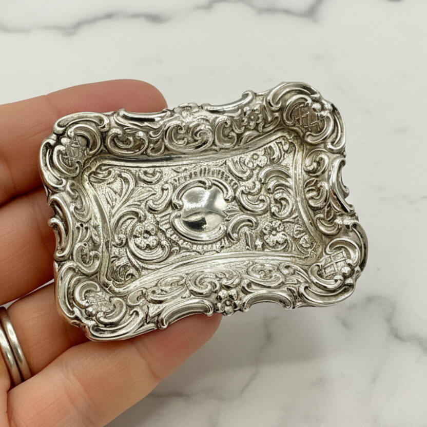 Antique Small Repousse Silver Tray held in a hand