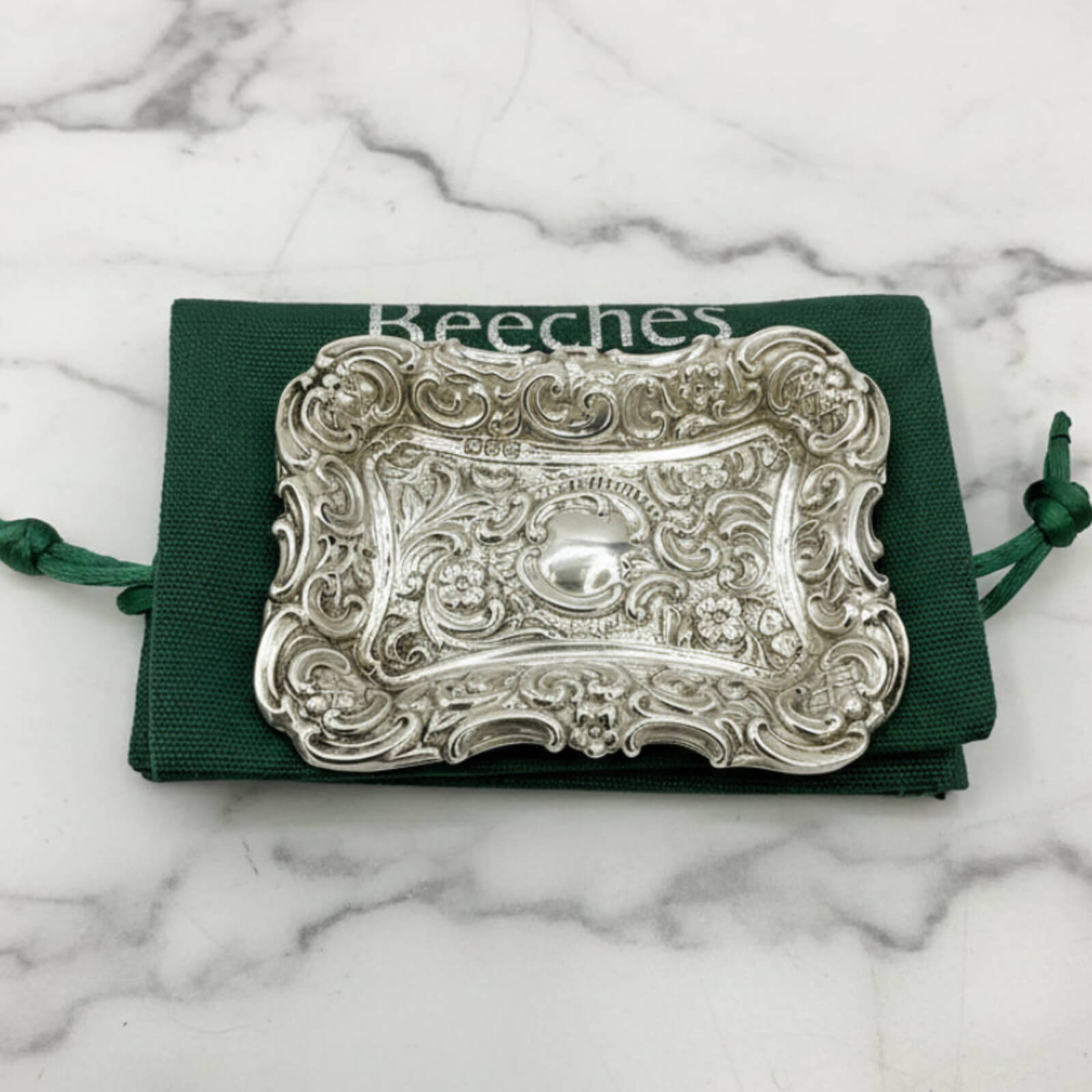 Antique Small Repousse Silver Tray on a green bag and marble surface